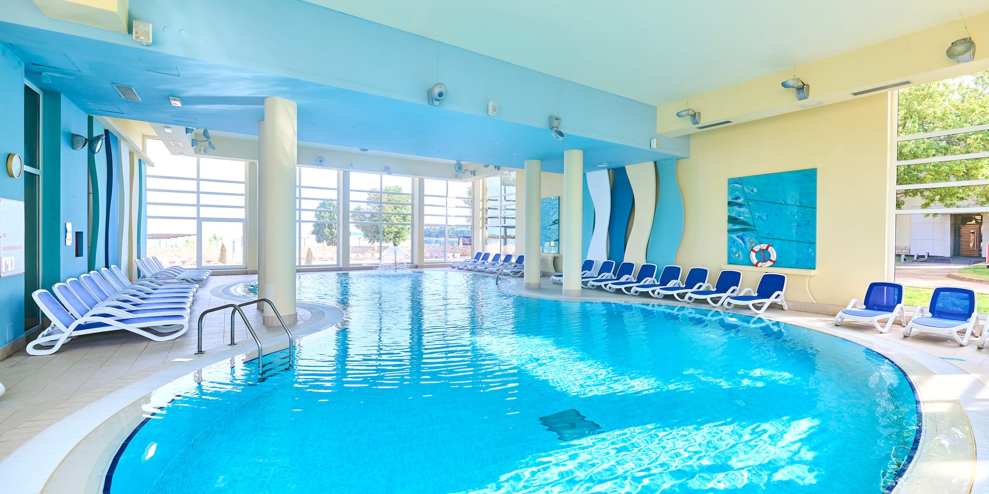 a swimming pool with chairs in the middle