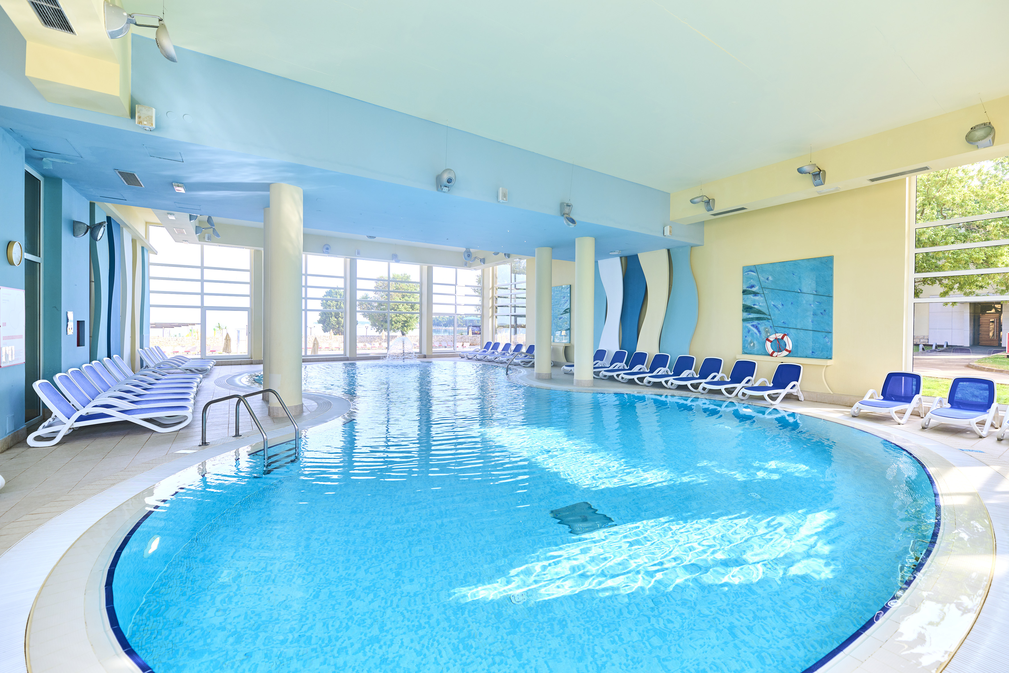 a swimming pool with chairs in the middle