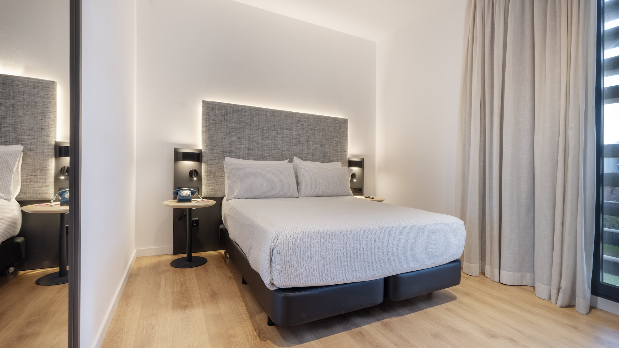 a bed with a headboard and a table in a room