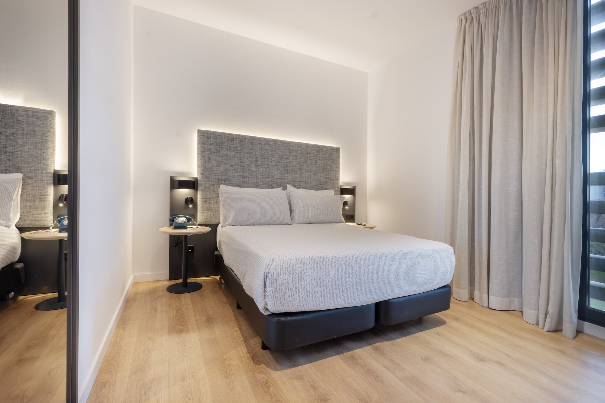 a bed with a headboard and a table in a room