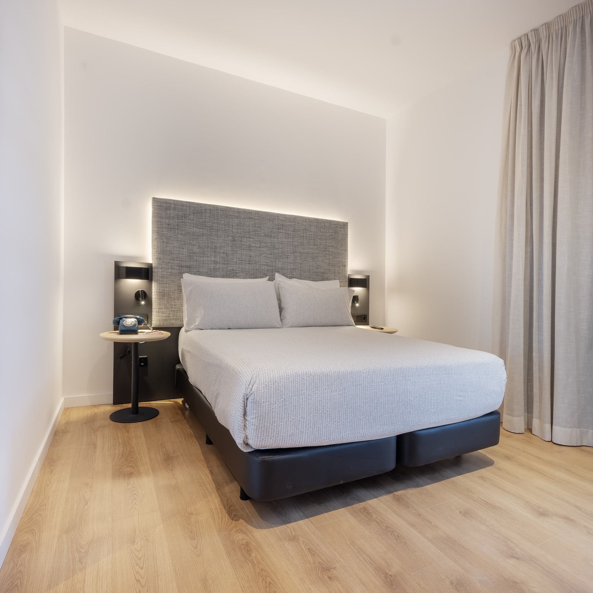 a bed with a headboard and a table in a room