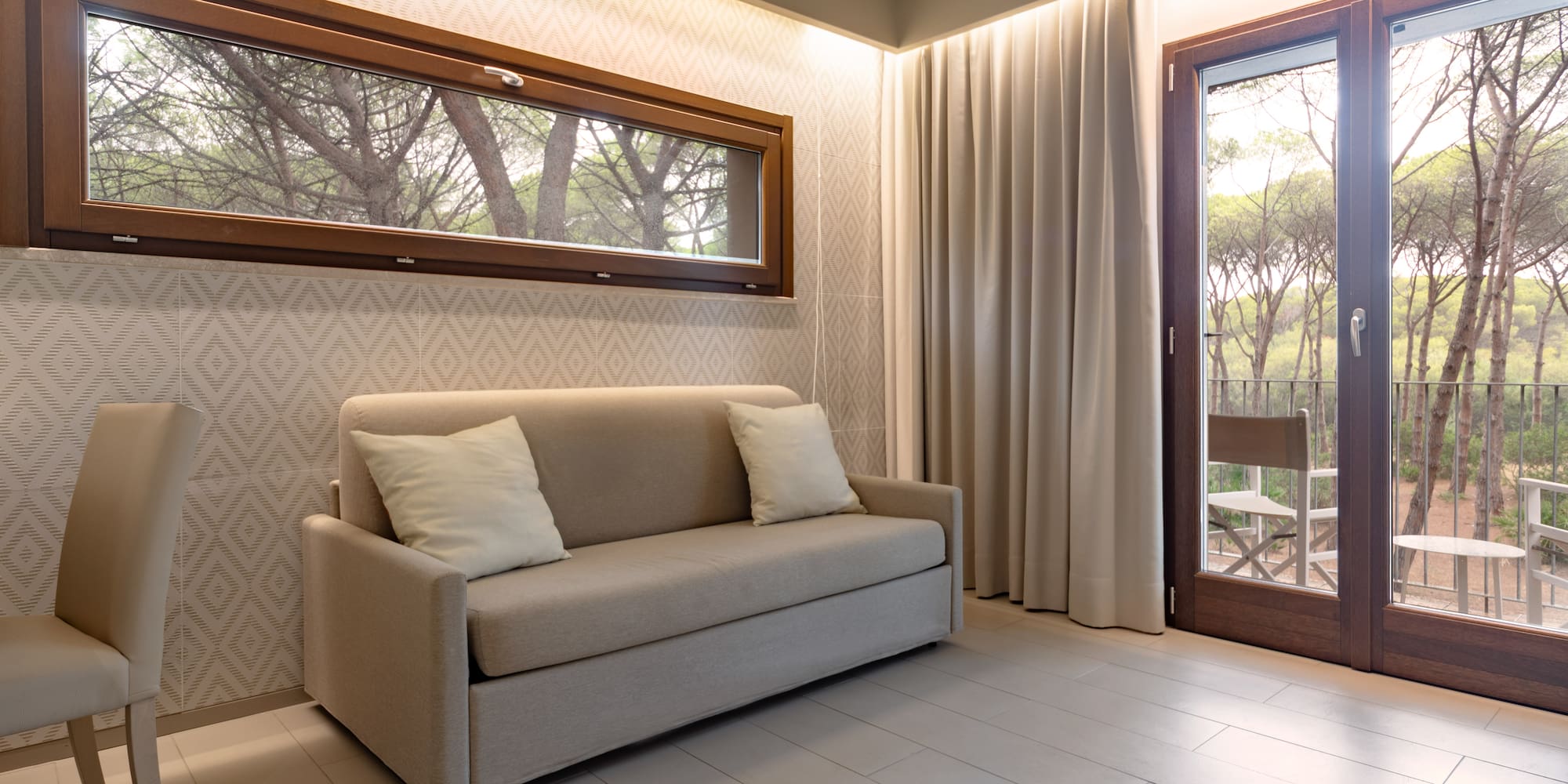 a couch in a room with a door and windows