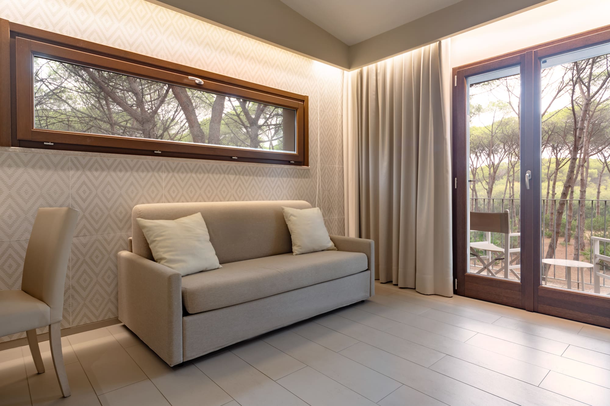 a couch in a room with a door and windows