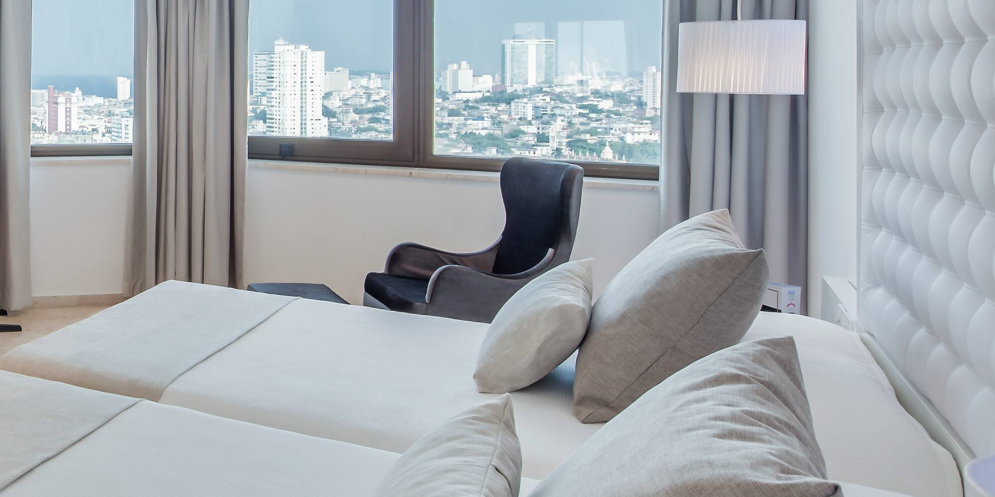 a room with a large bed and a chair