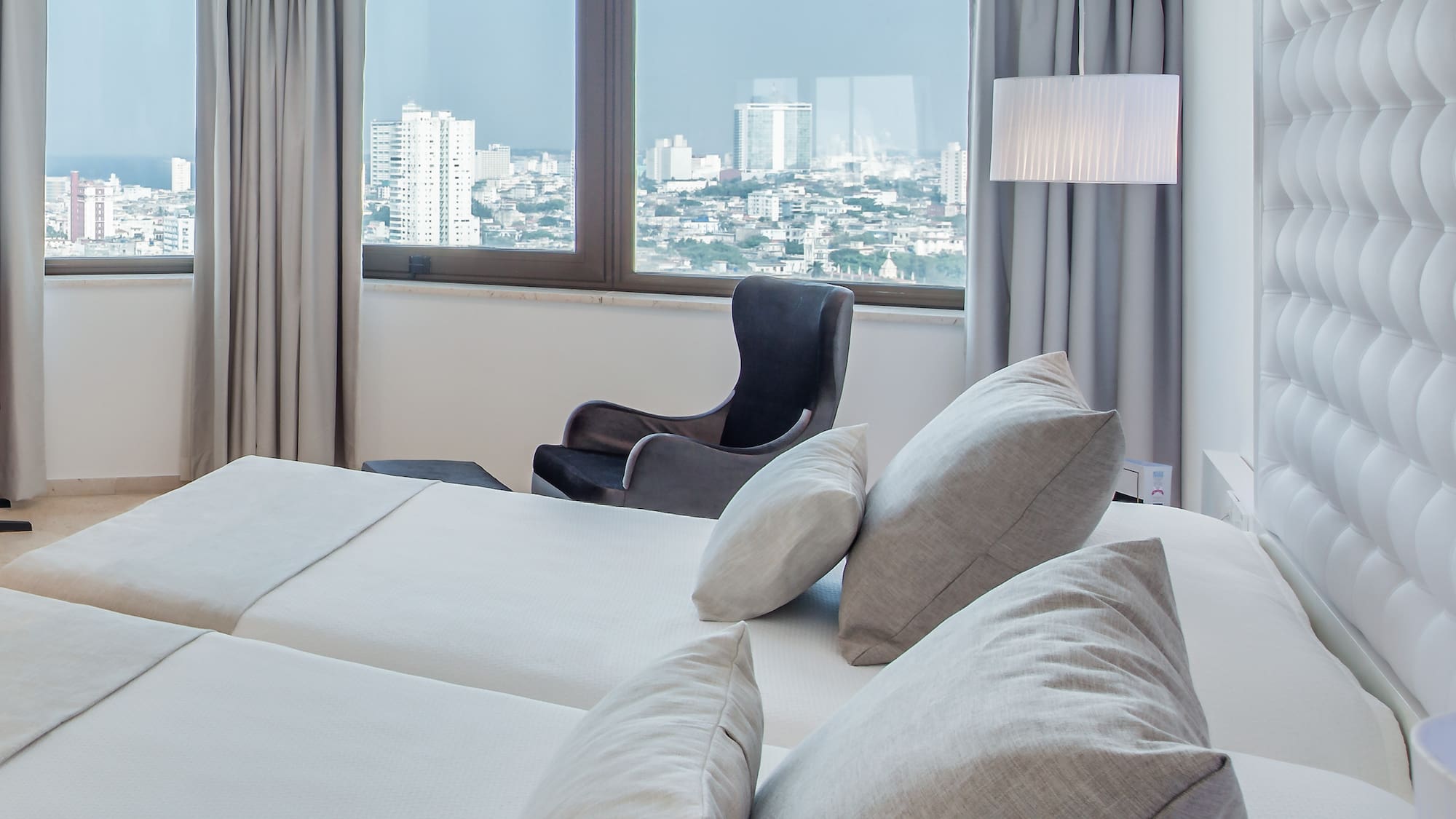 a room with a large bed and a chair