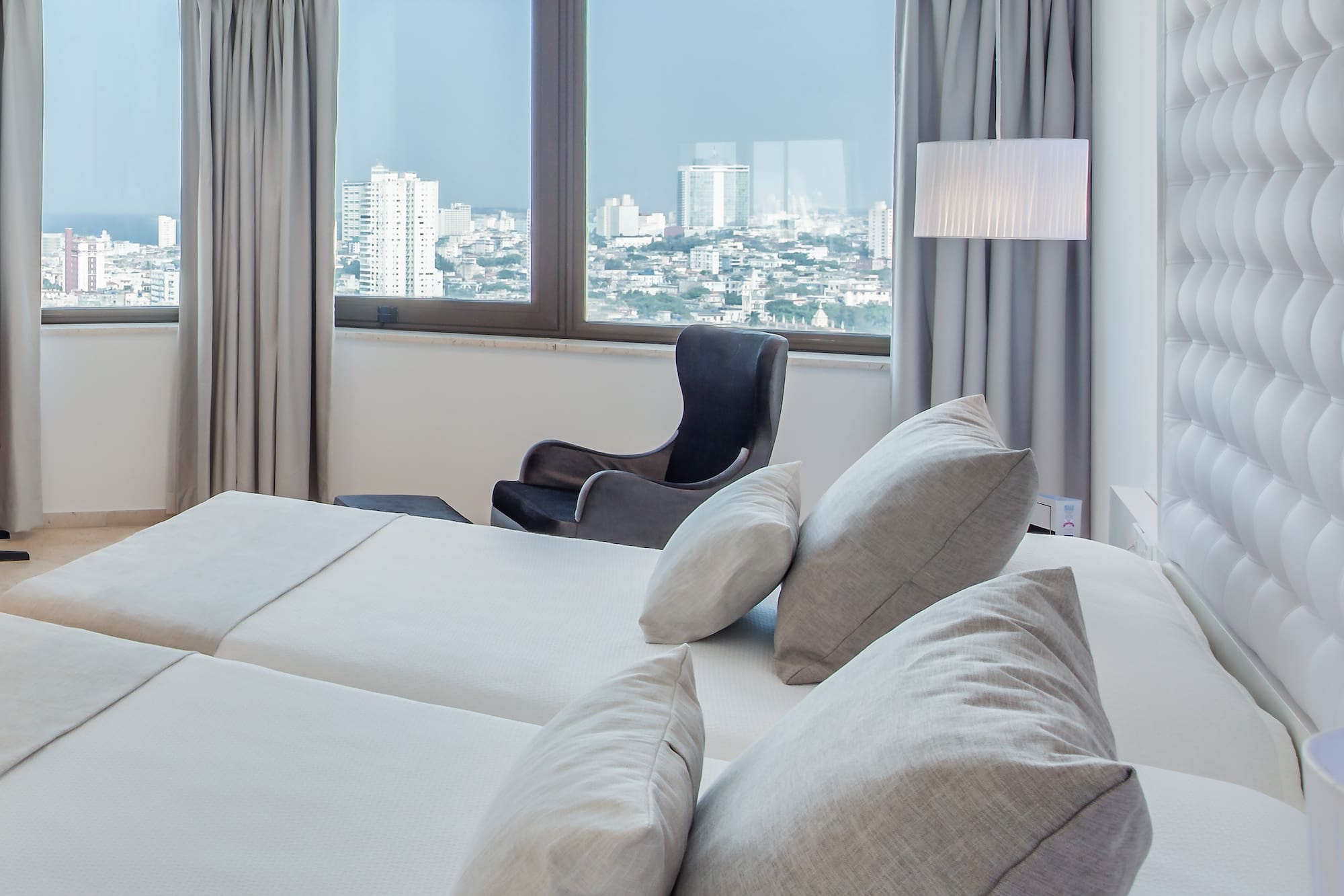 a room with a large bed and a chair