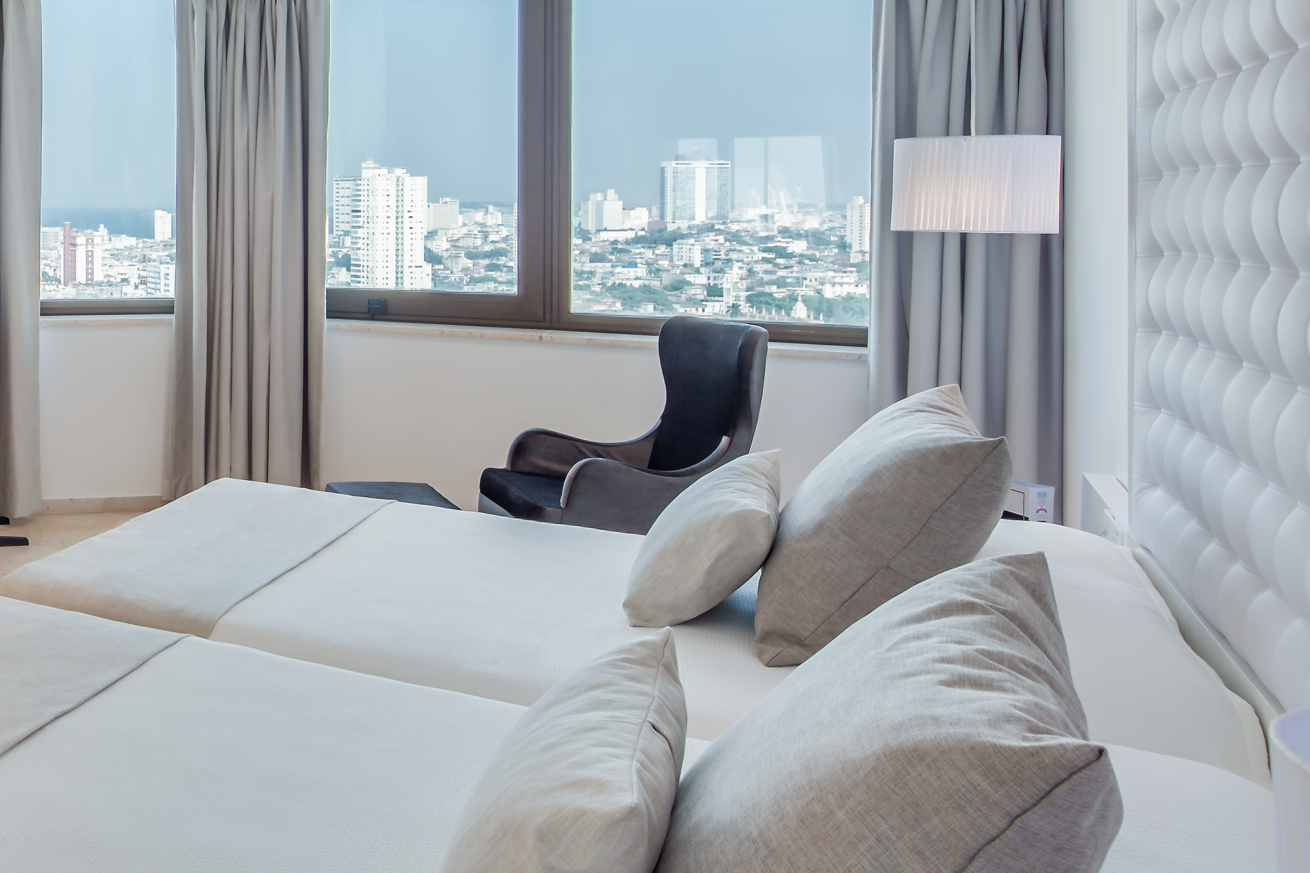 a room with a large bed and a chair