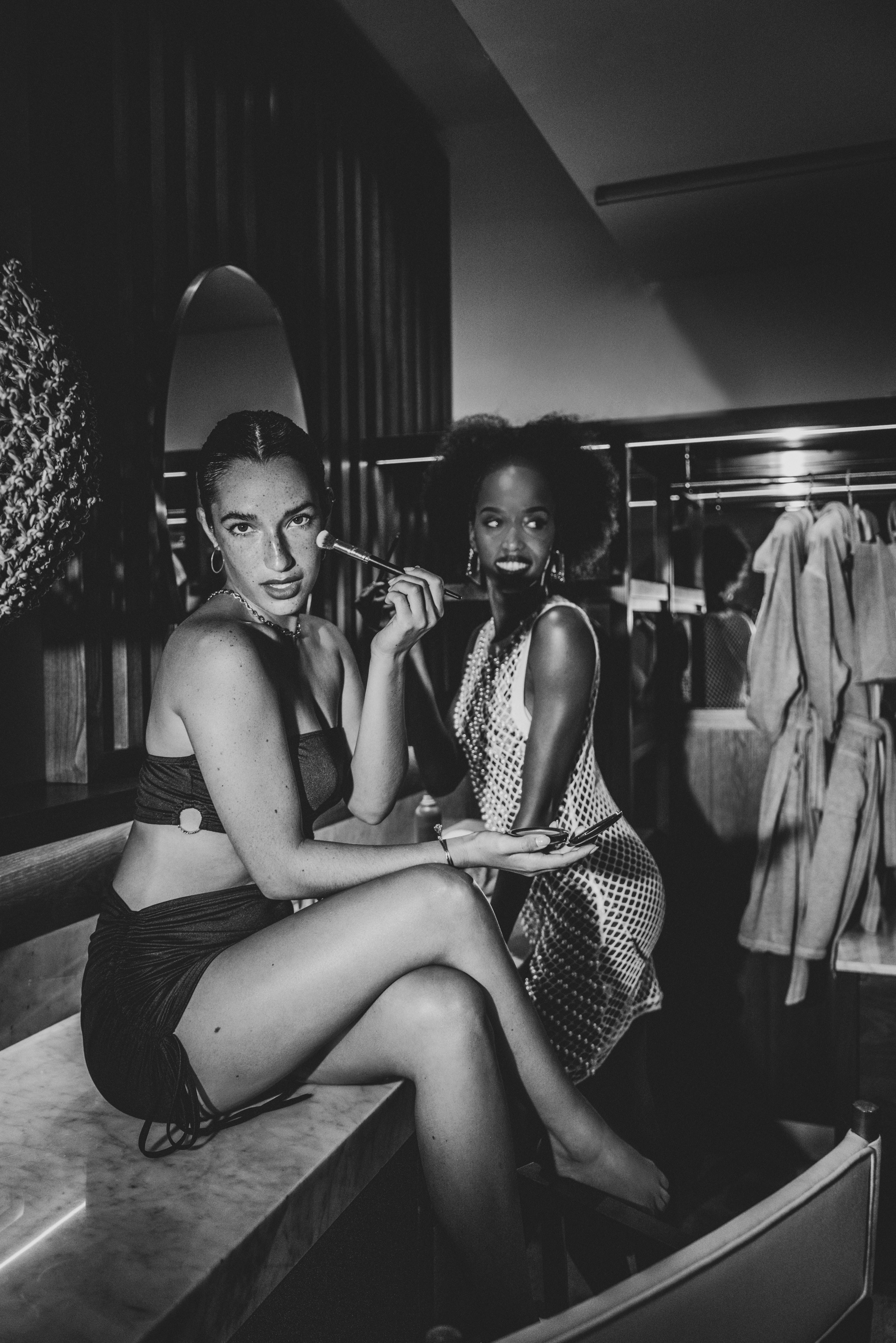 a group of women sitting in a dressing room
