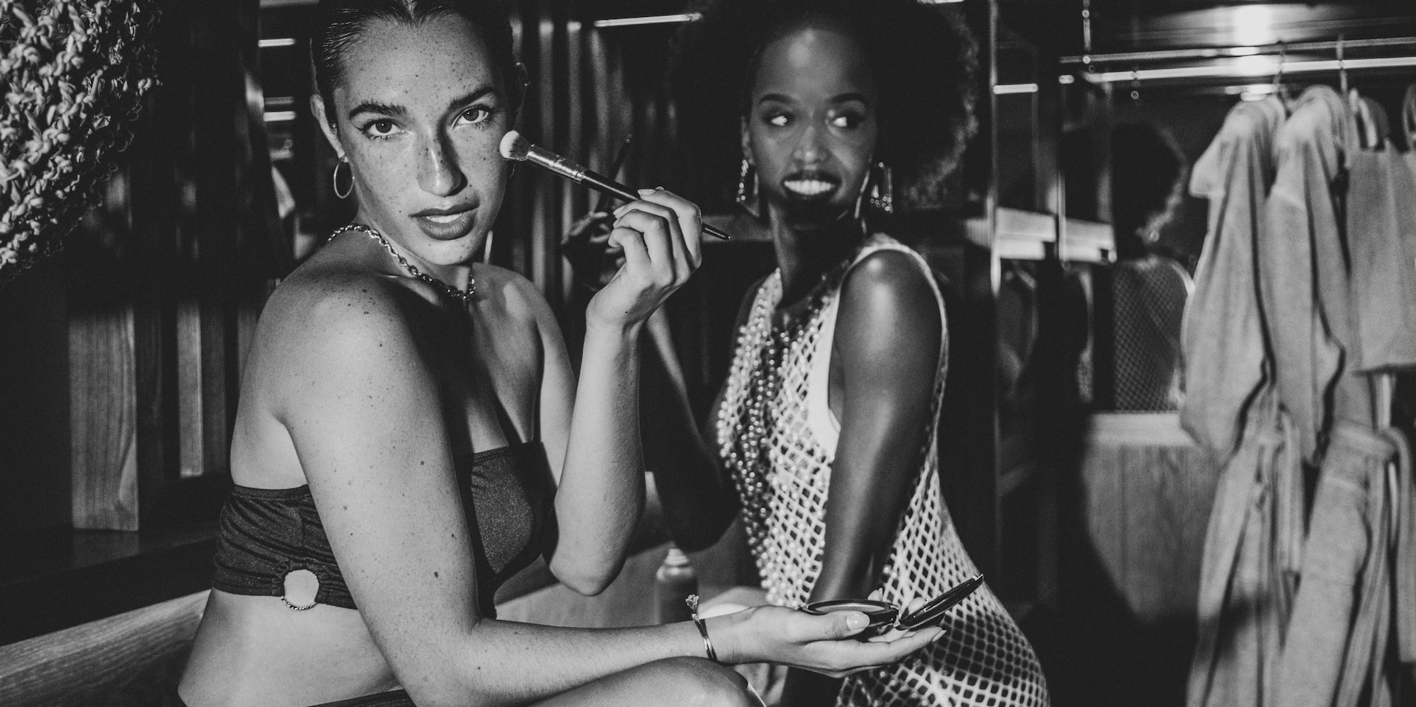 a group of women sitting in a dressing room