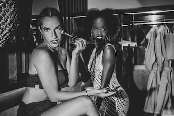 a group of women sitting in a dressing room