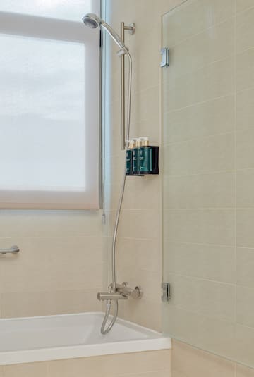 a shower with a tub and shower head