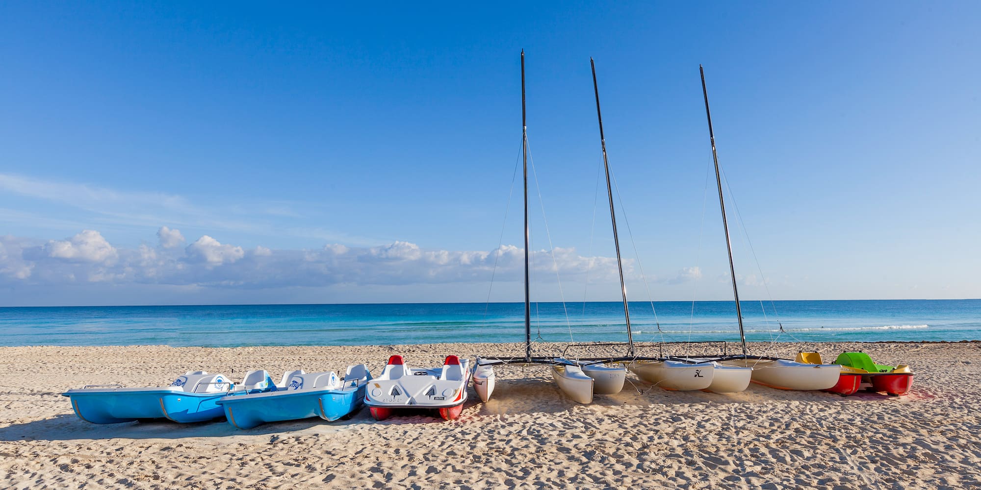 a group of boats on a beach