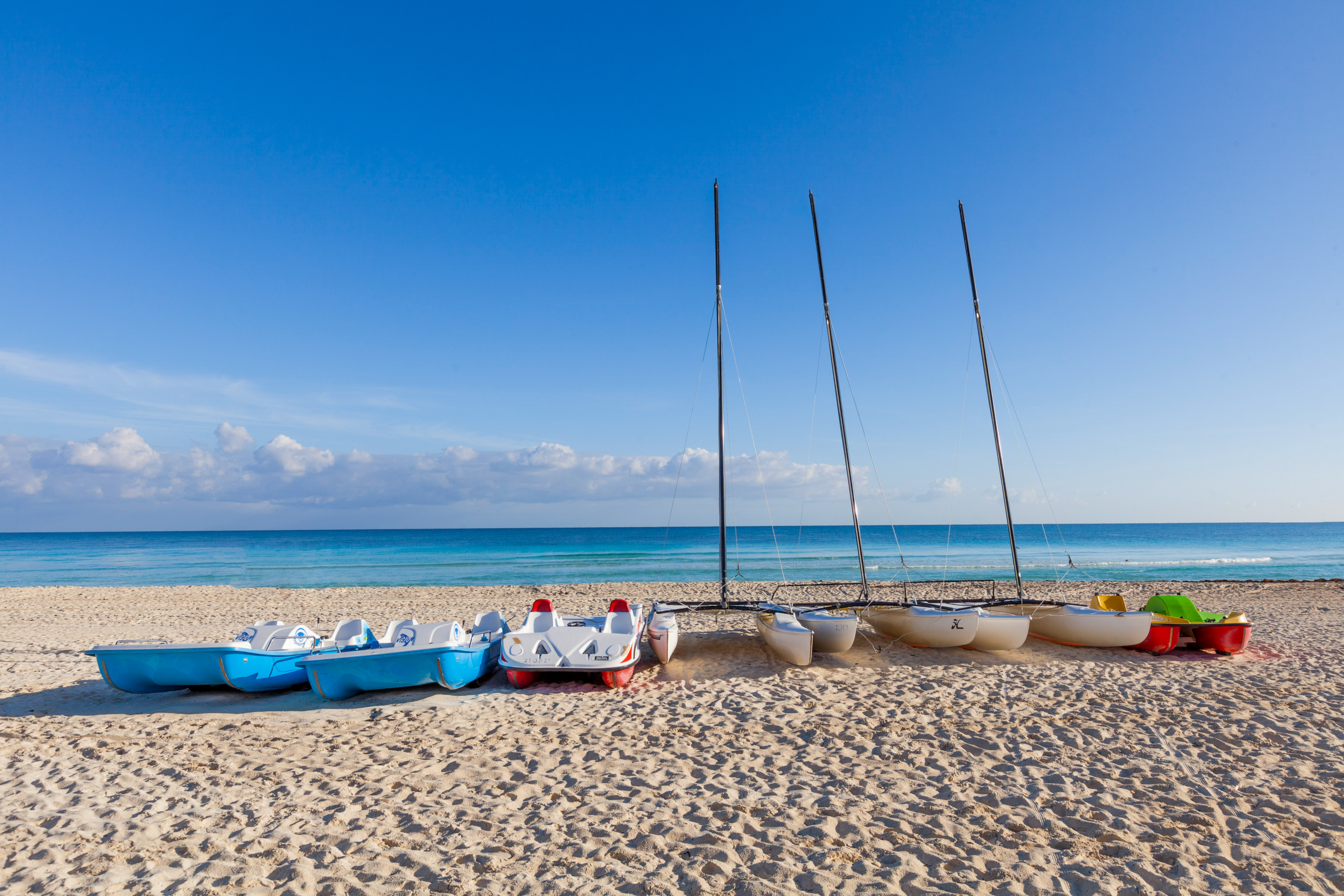 a group of boats on a beach