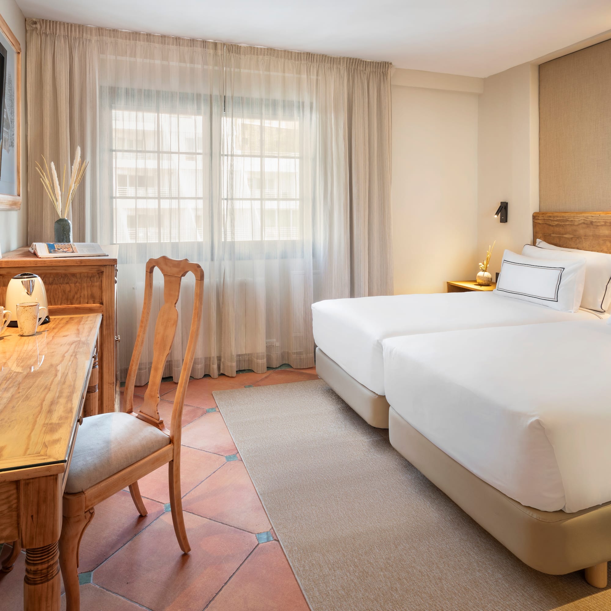 a room with two beds and a desk