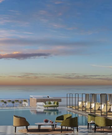 a pool with chairs and tables on top of it