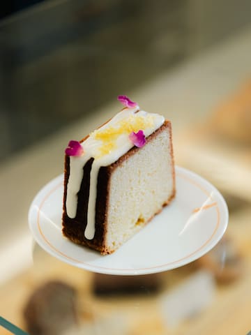 a piece of cake with icing and flowers on top