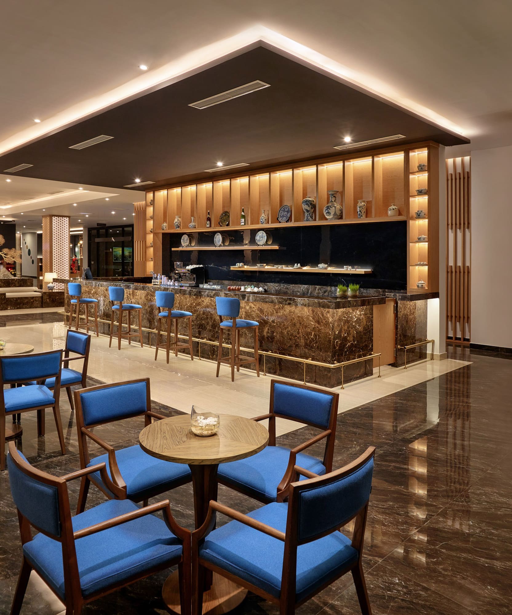 a room with a bar and tables and chairs