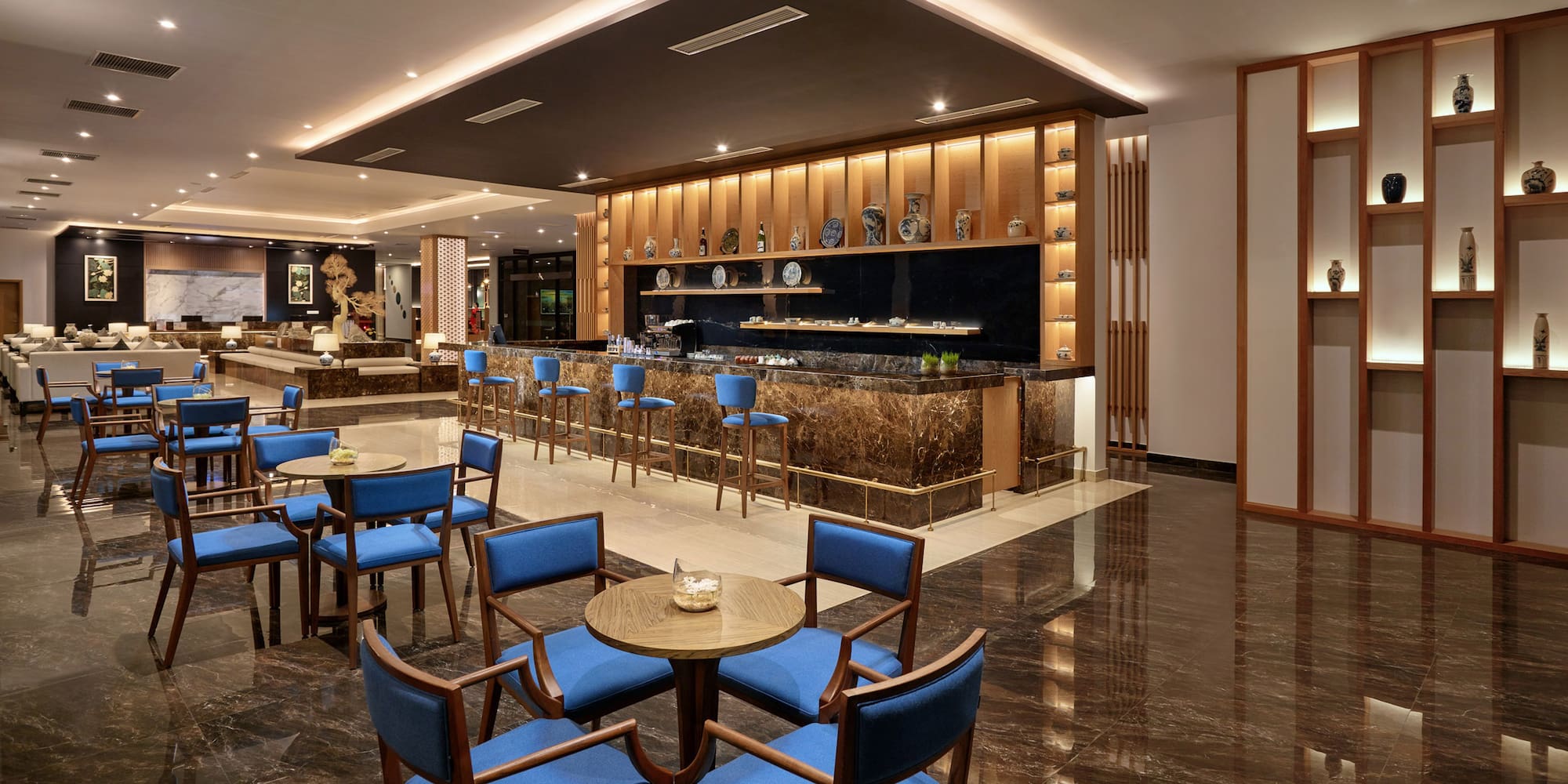 a room with a bar and tables and chairs