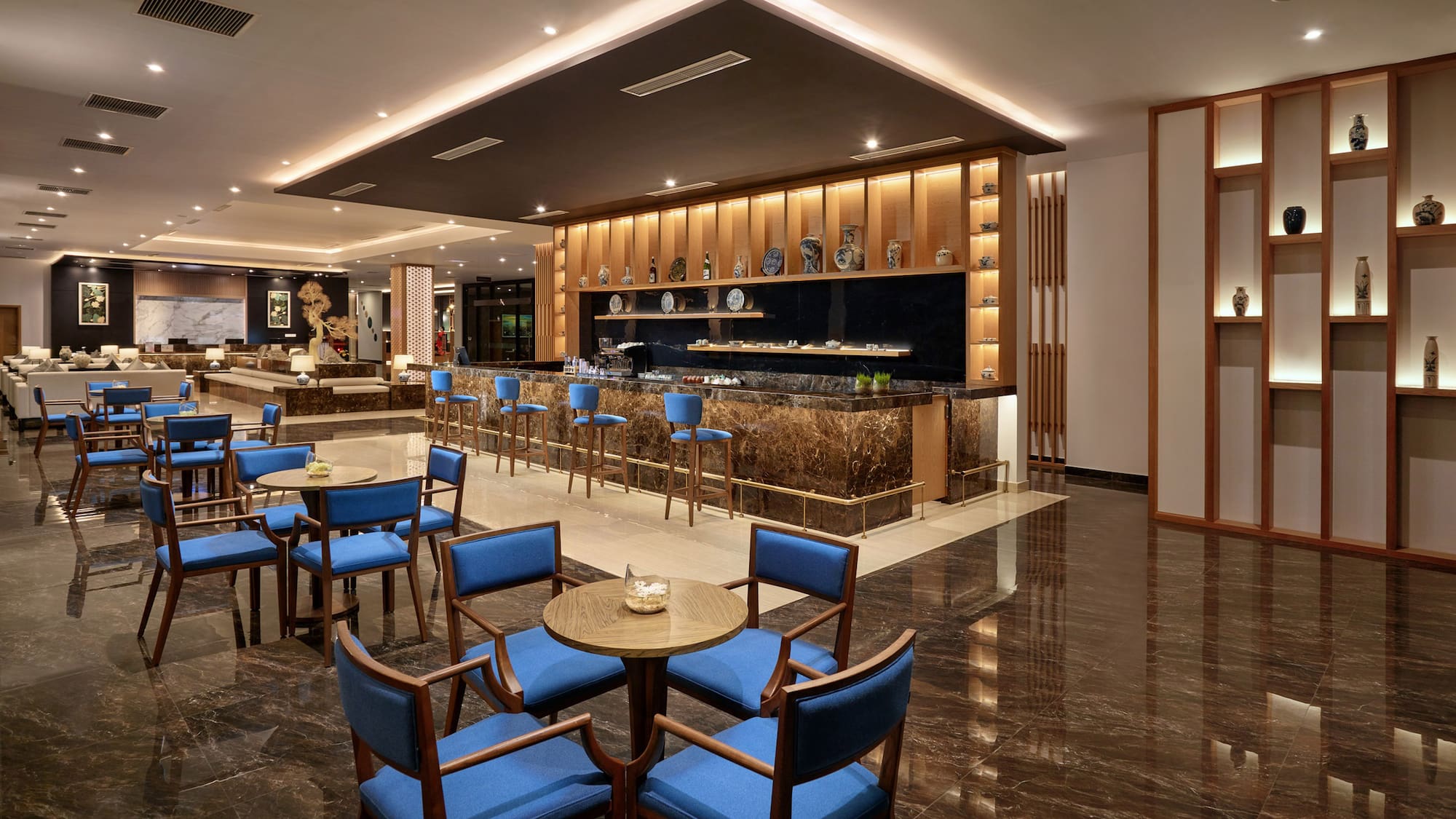 a room with a bar and tables and chairs