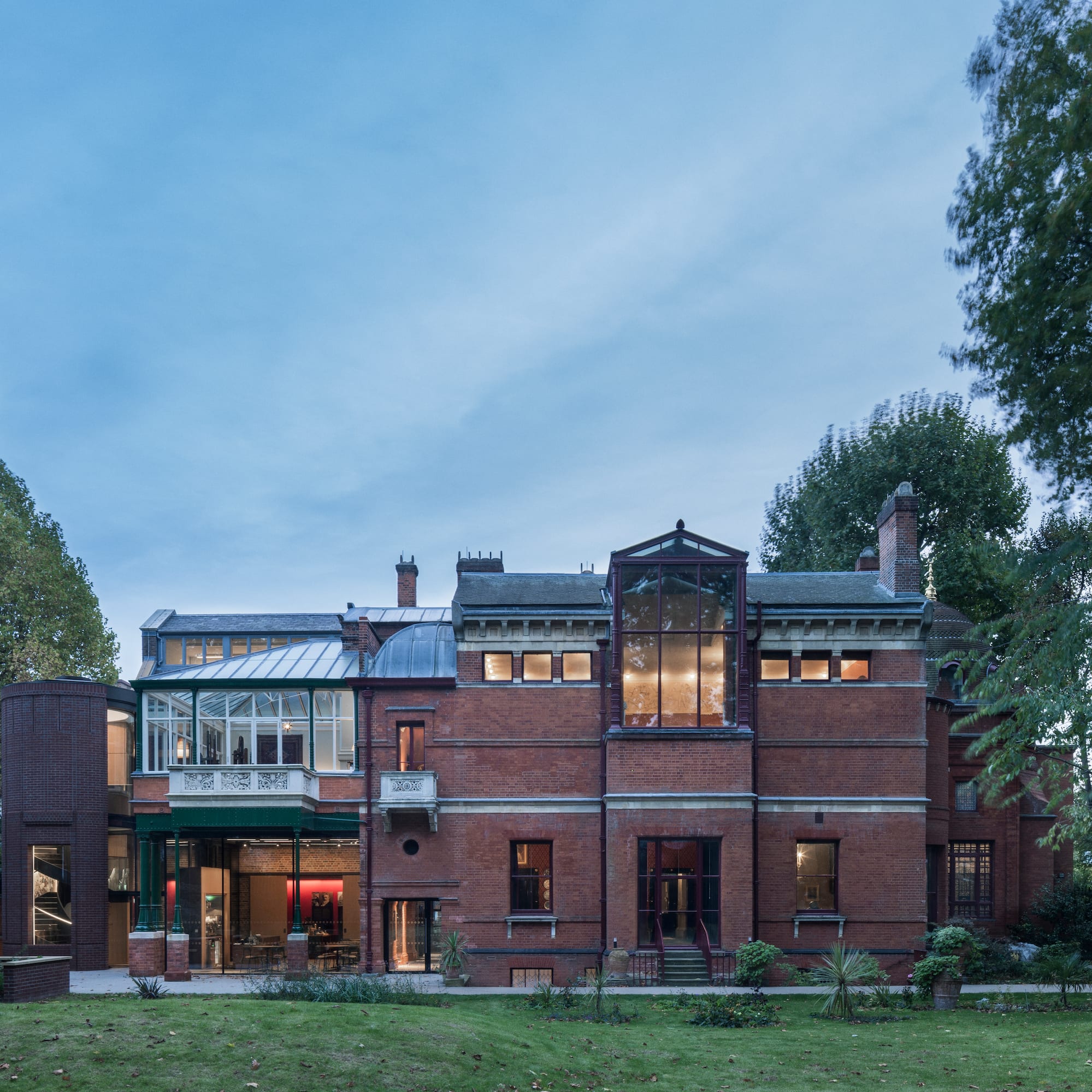 a large brick building with trees in the background