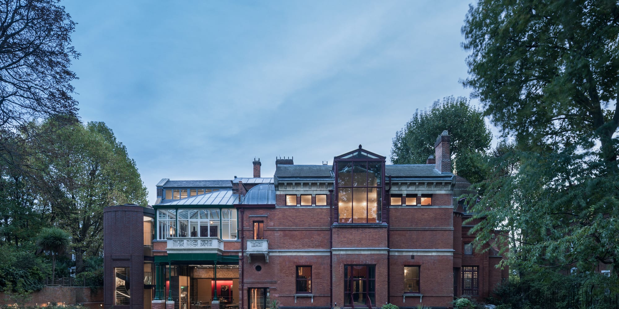 a large brick building with trees in the background