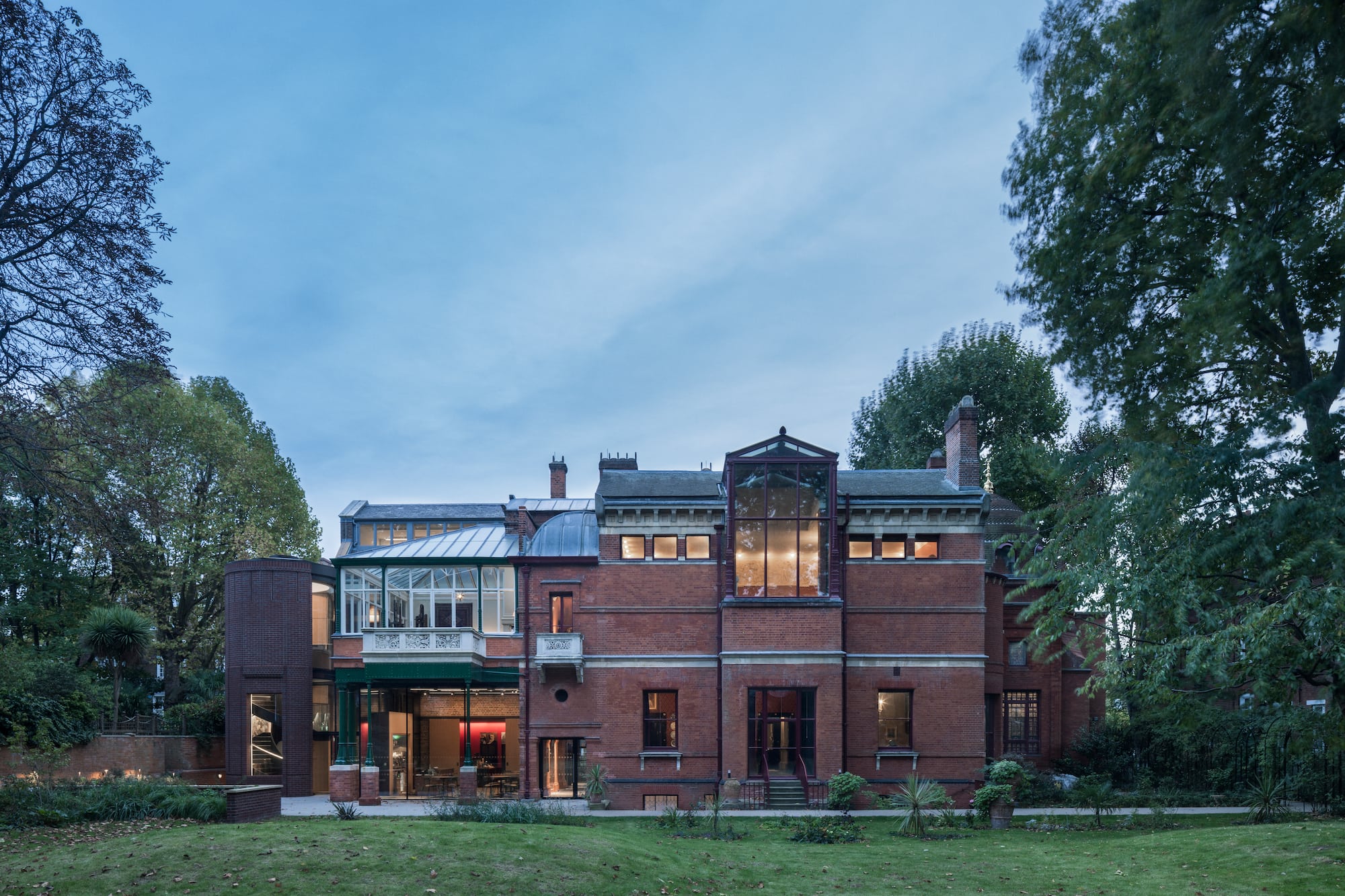 a large brick building with trees in the background