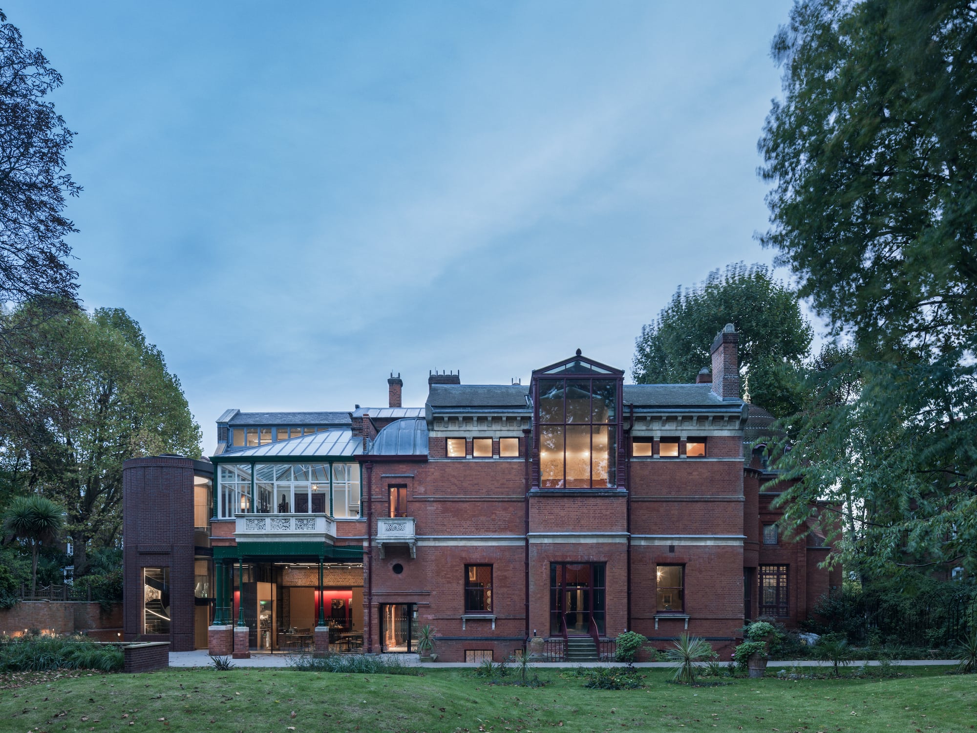 a large brick building with trees in the background