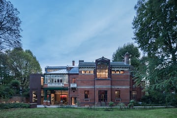 a large brick building with trees in the background