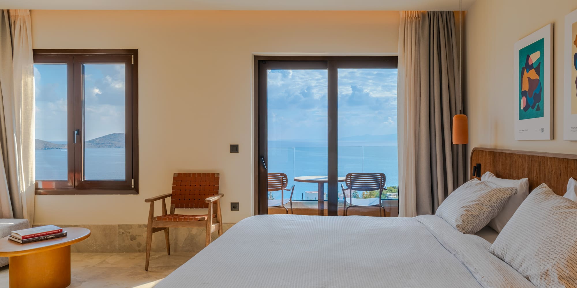 a bedroom with a bed and chairs and a table with chairs