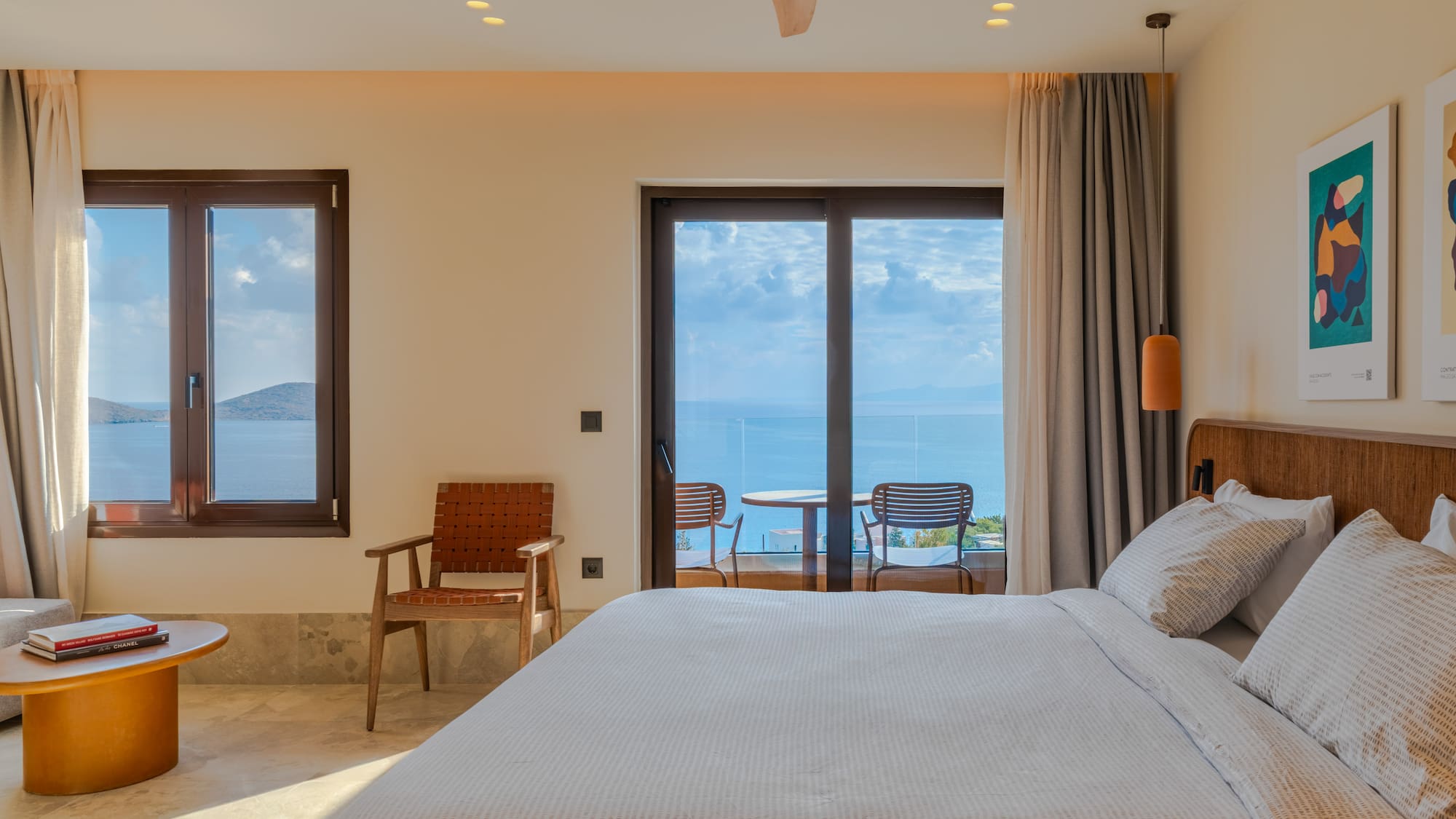 a bedroom with a bed and chairs and a table with chairs