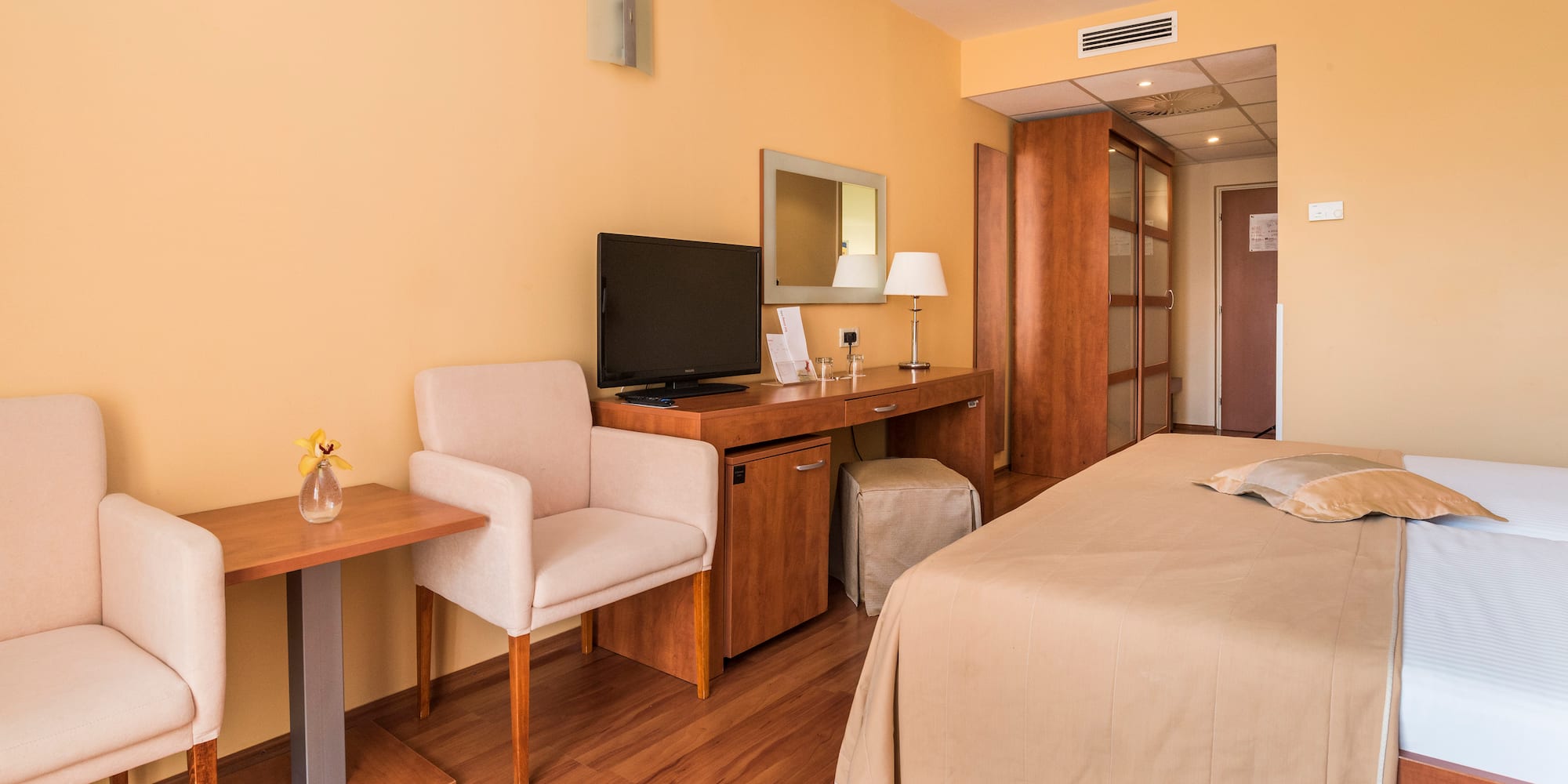 a room with a bed and a desk and chair