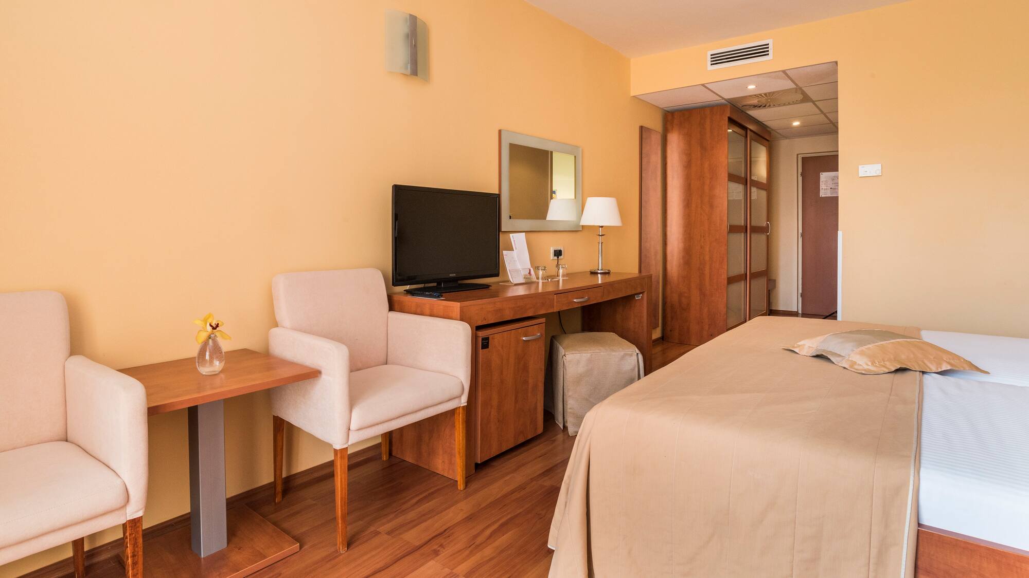 a room with a bed and a desk and chair