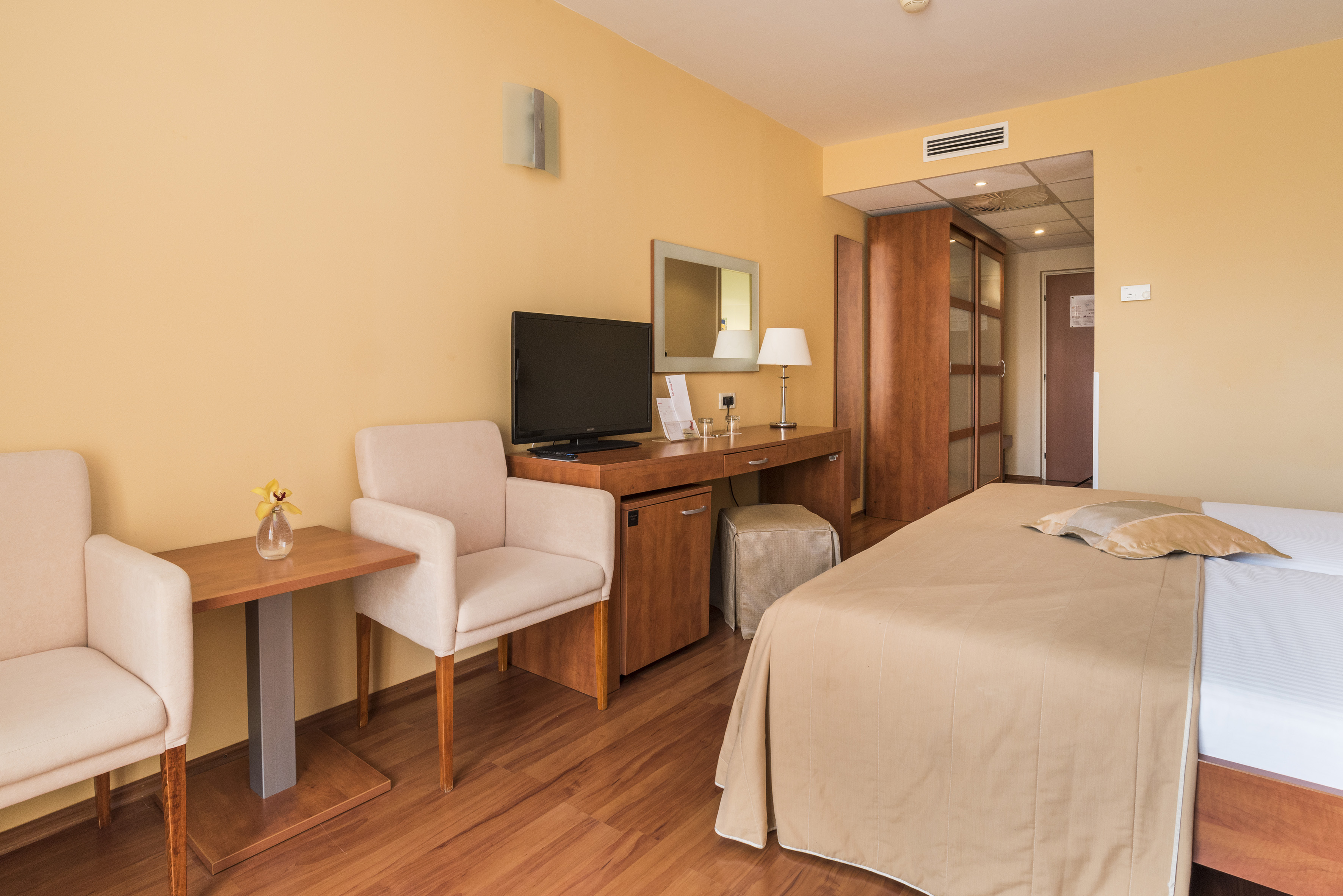 a room with a bed and a desk and chair