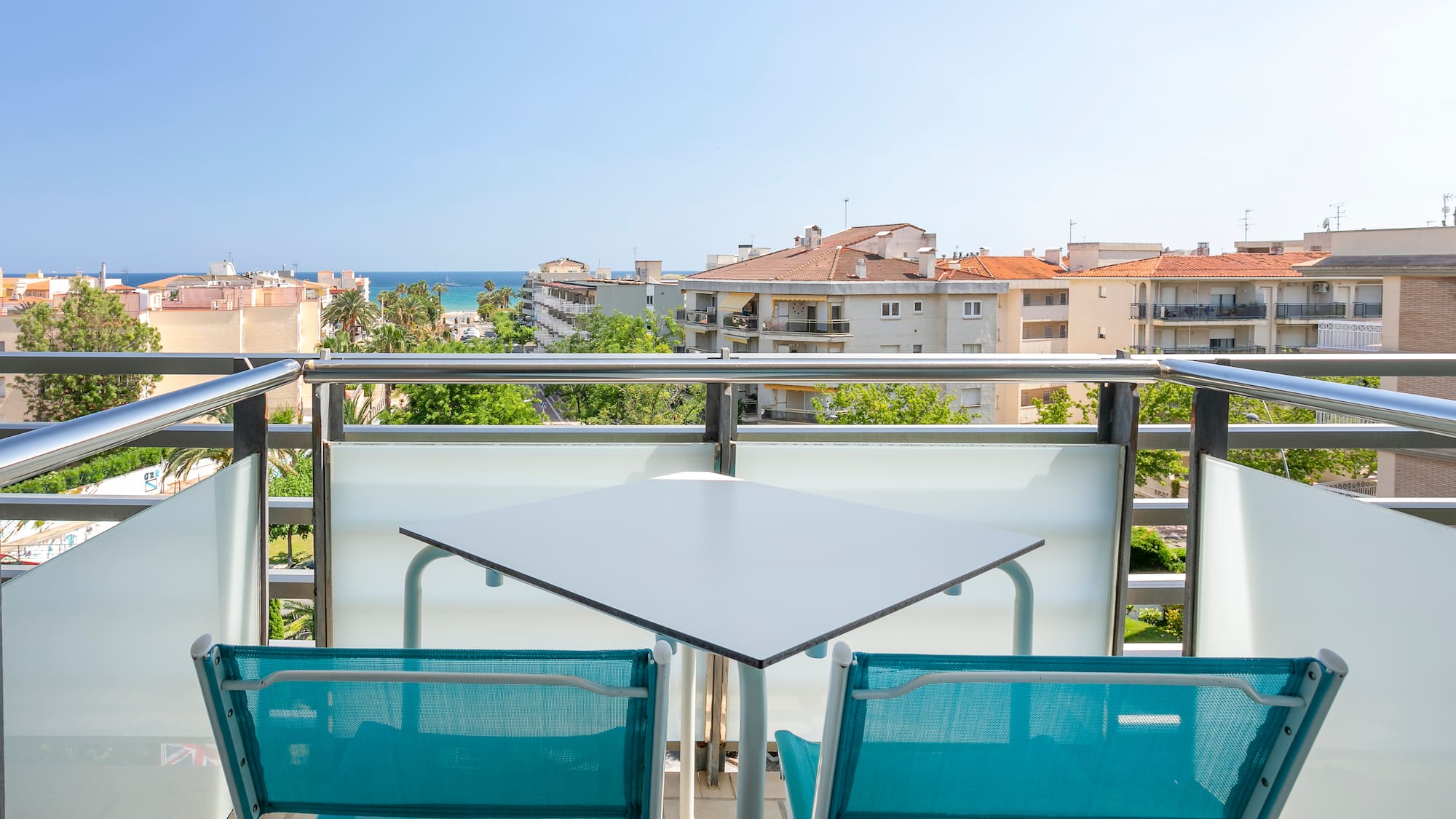 a table and chairs on a balcony