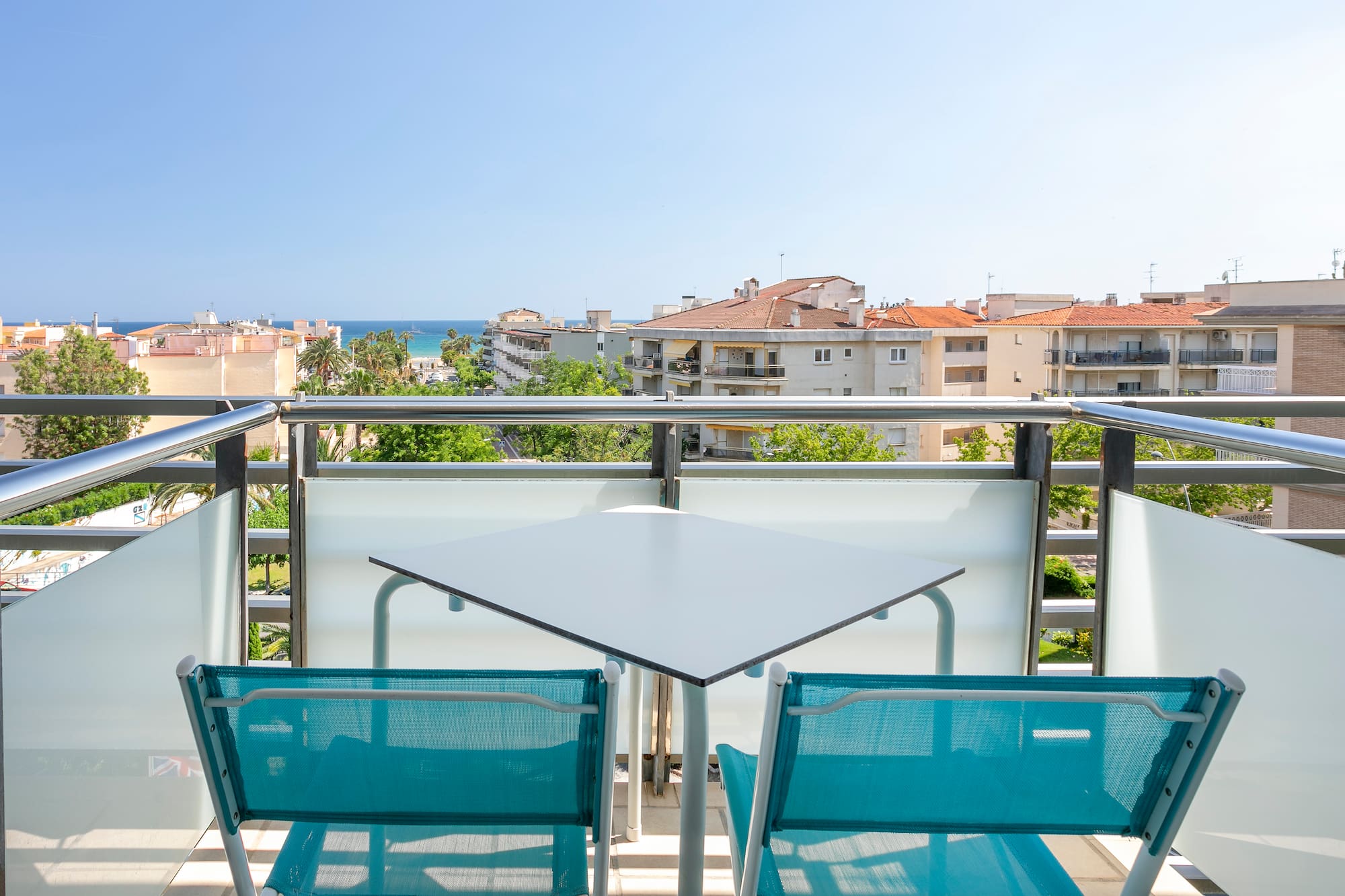 a table and chairs on a balcony