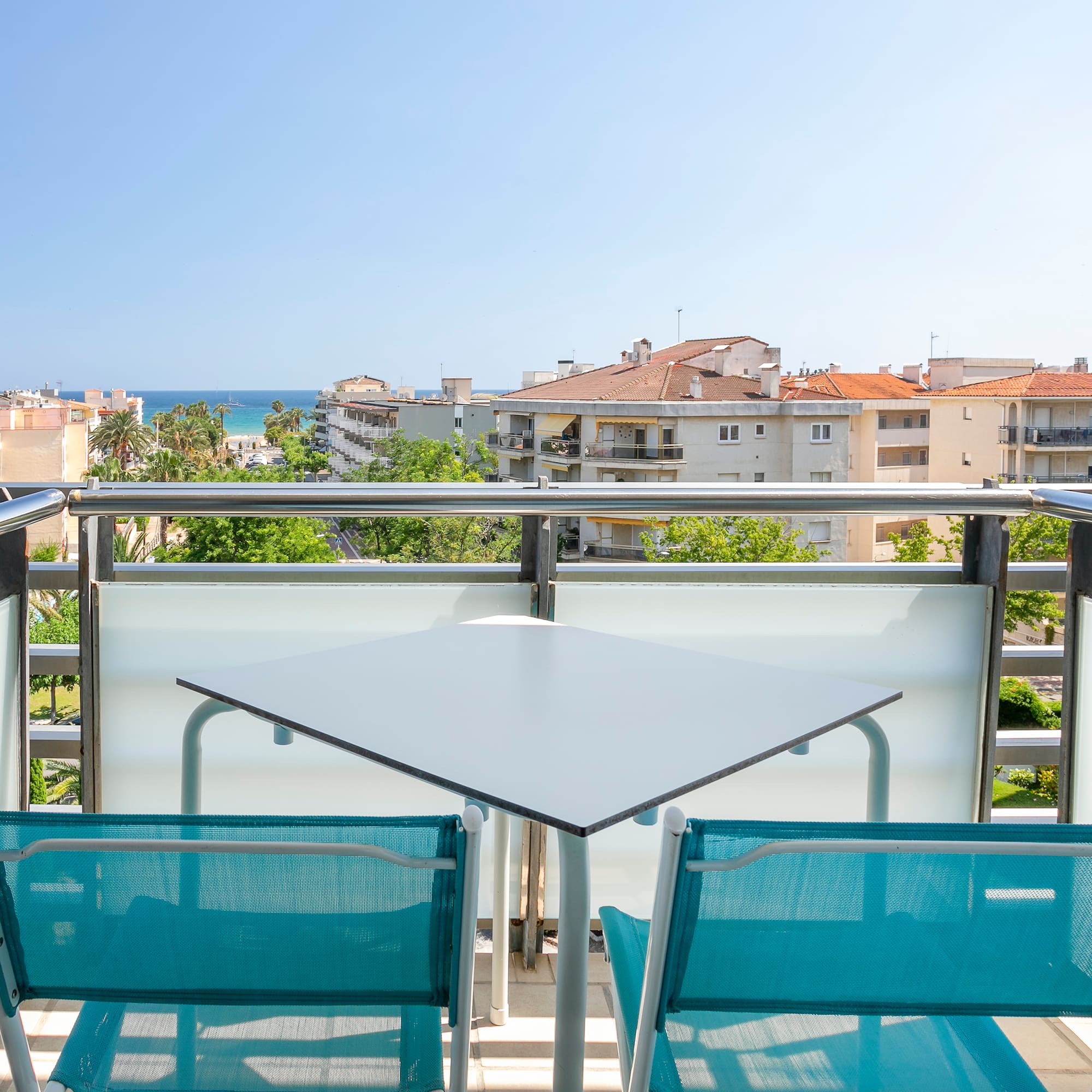 a table and chairs on a balcony