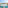 Balcony with table, chairs, coastal city, and ocean view.