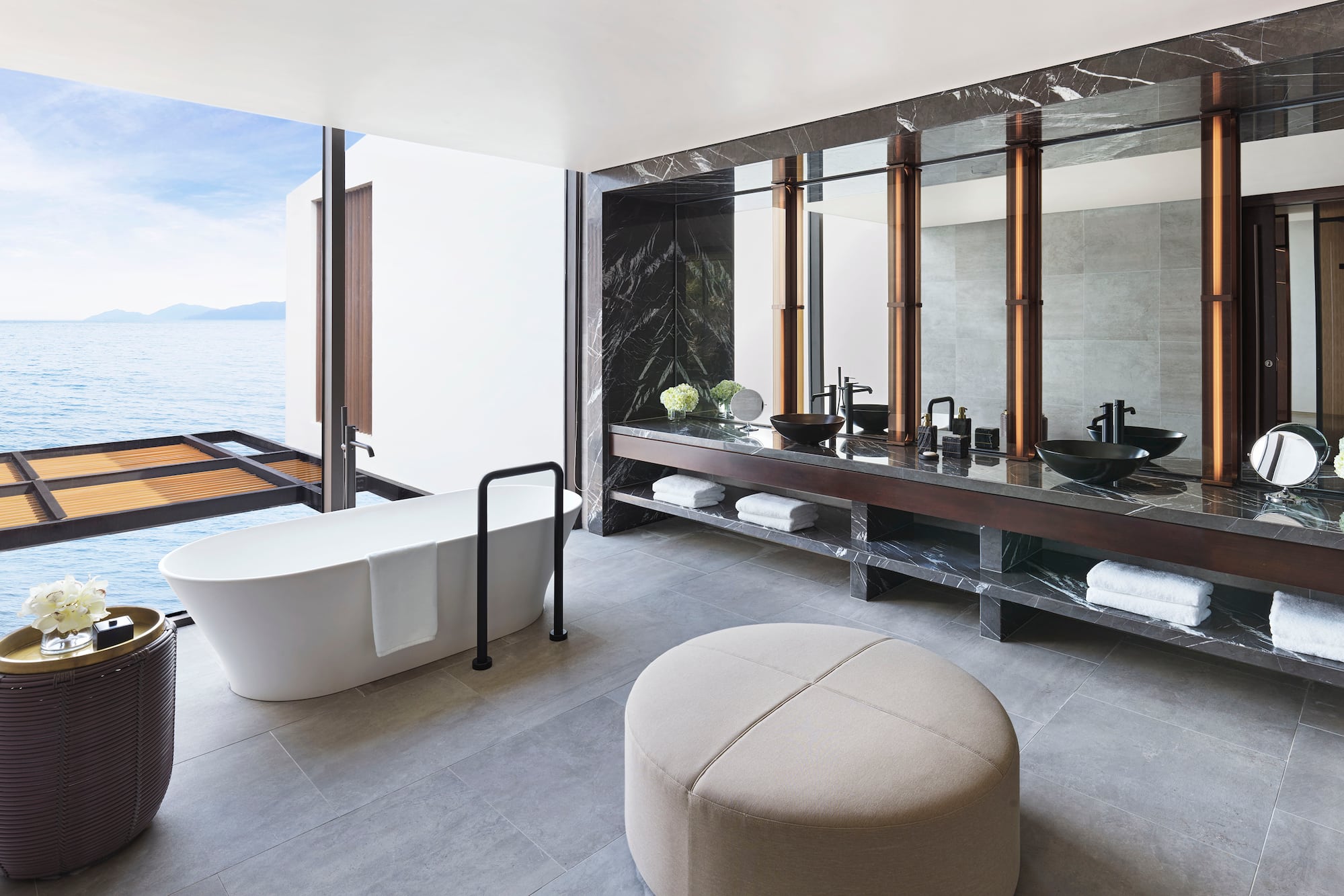 a bathroom with a tub and a large mirror
