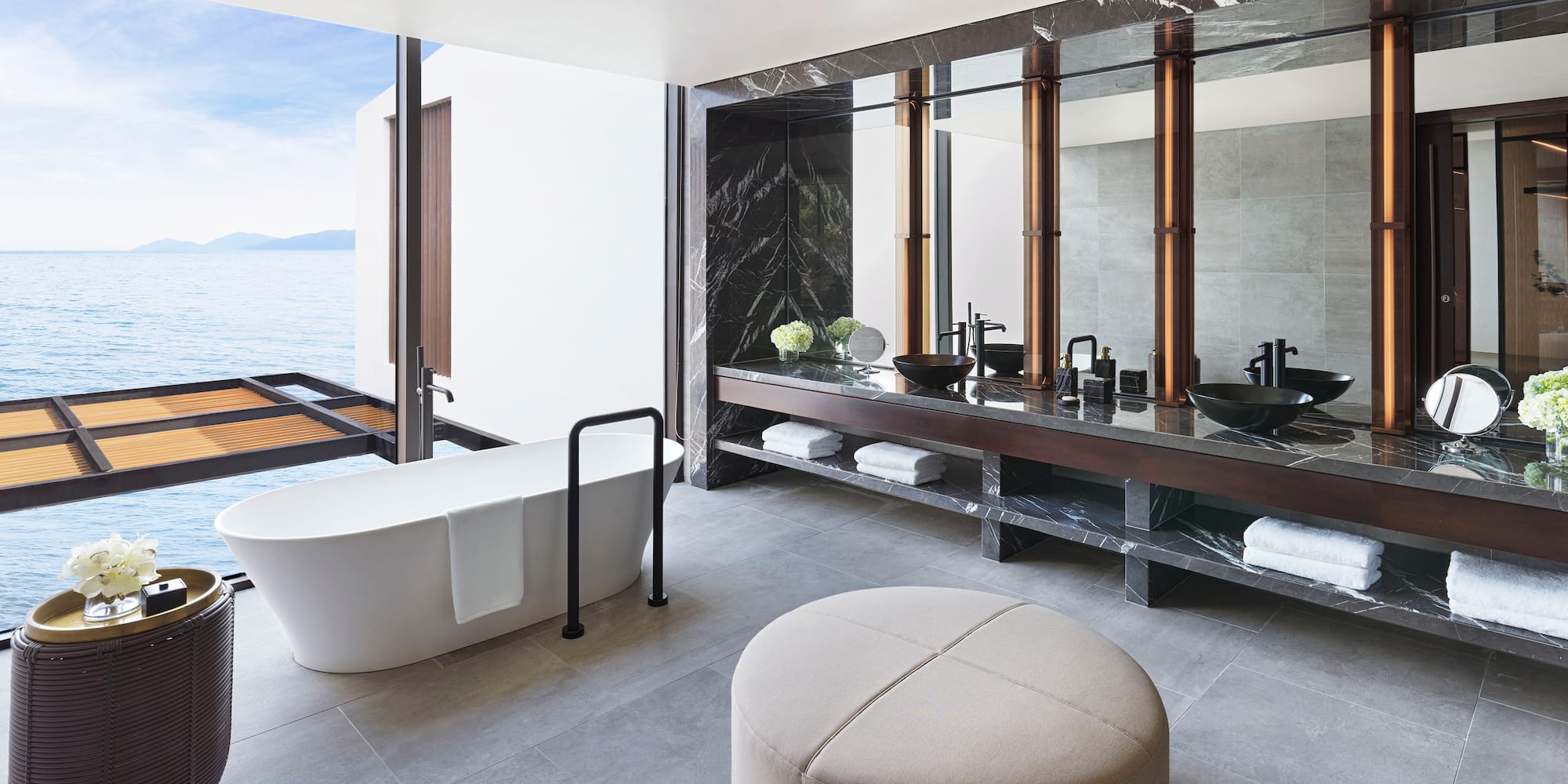 a bathroom with a tub and a large mirror