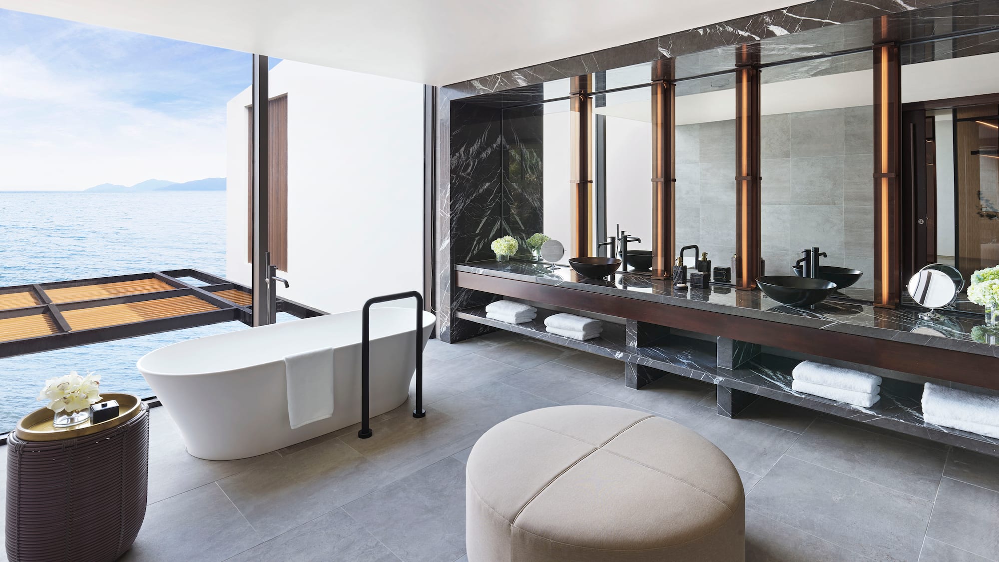 a bathroom with a tub and a large mirror