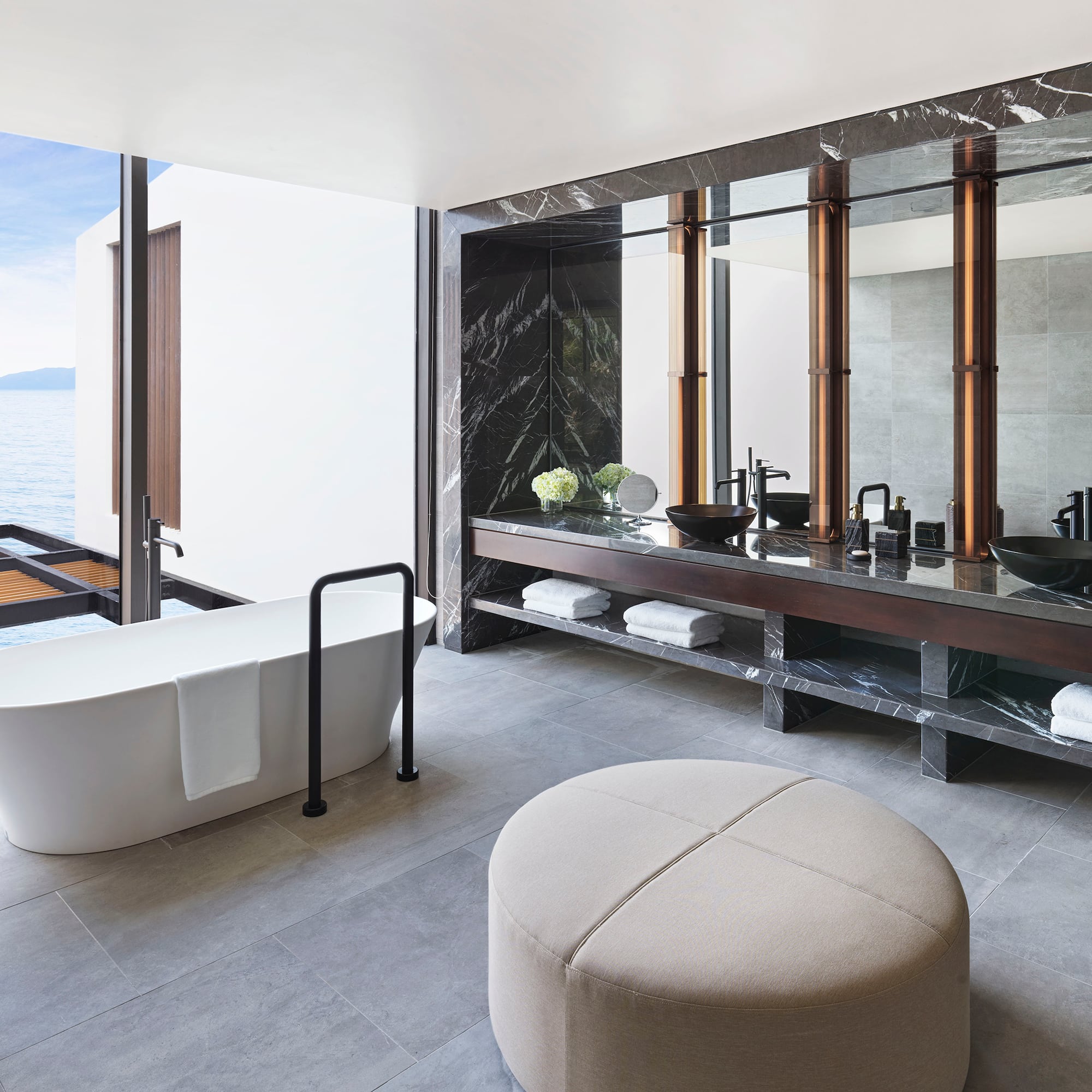 a bathroom with a tub and a large mirror
