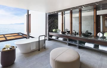 a bathroom with a tub and a large mirror