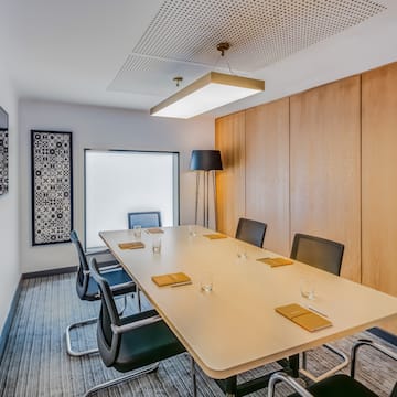 a conference room with a table and chairs