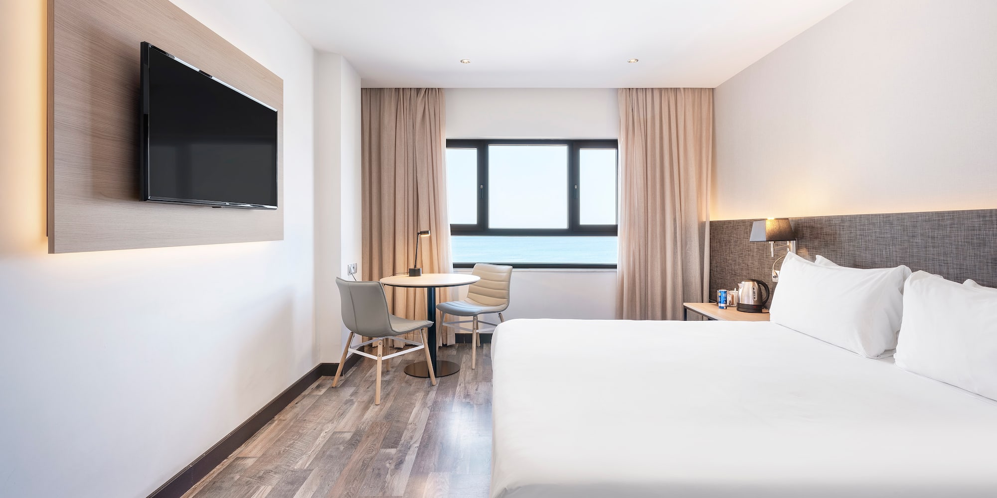 a room with a bed and a television