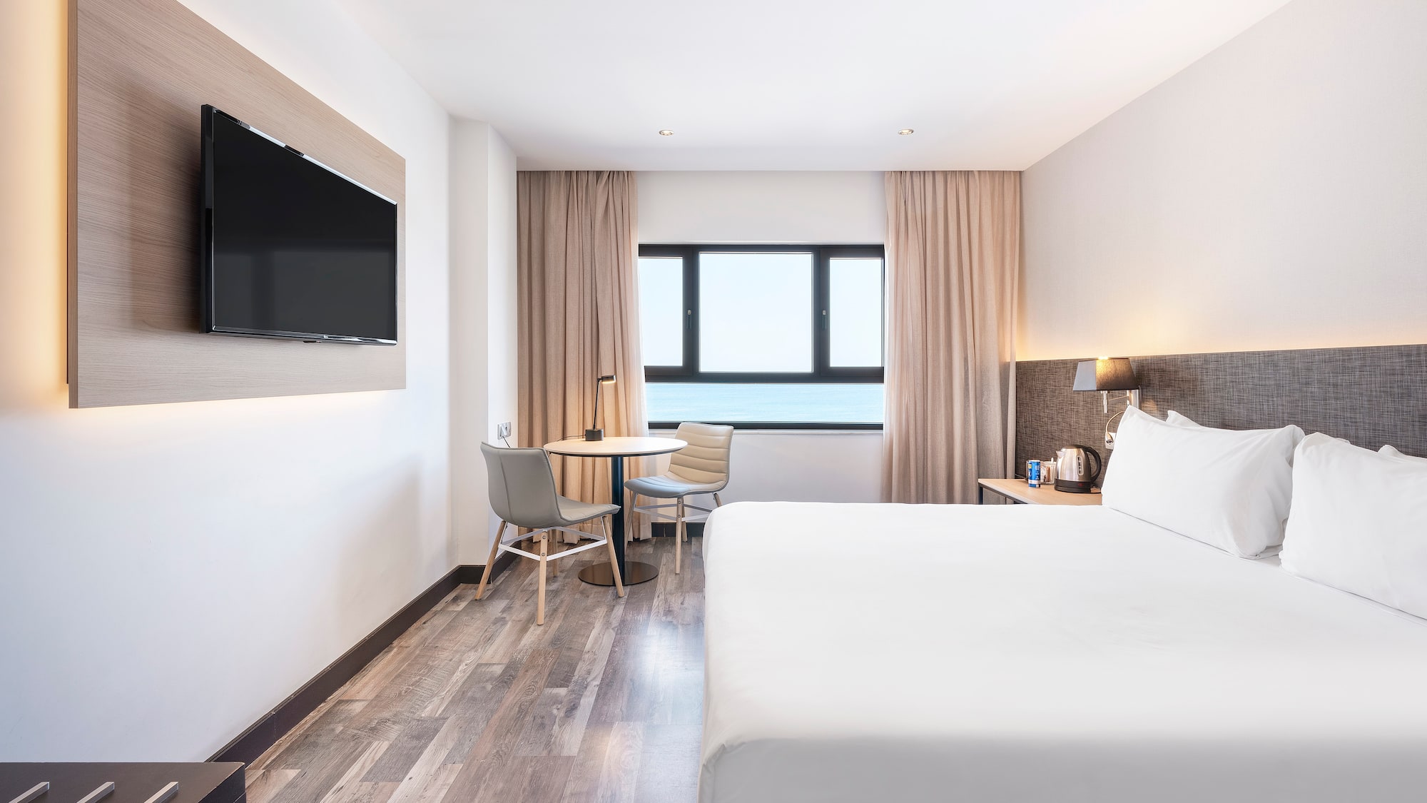 a room with a bed and a television