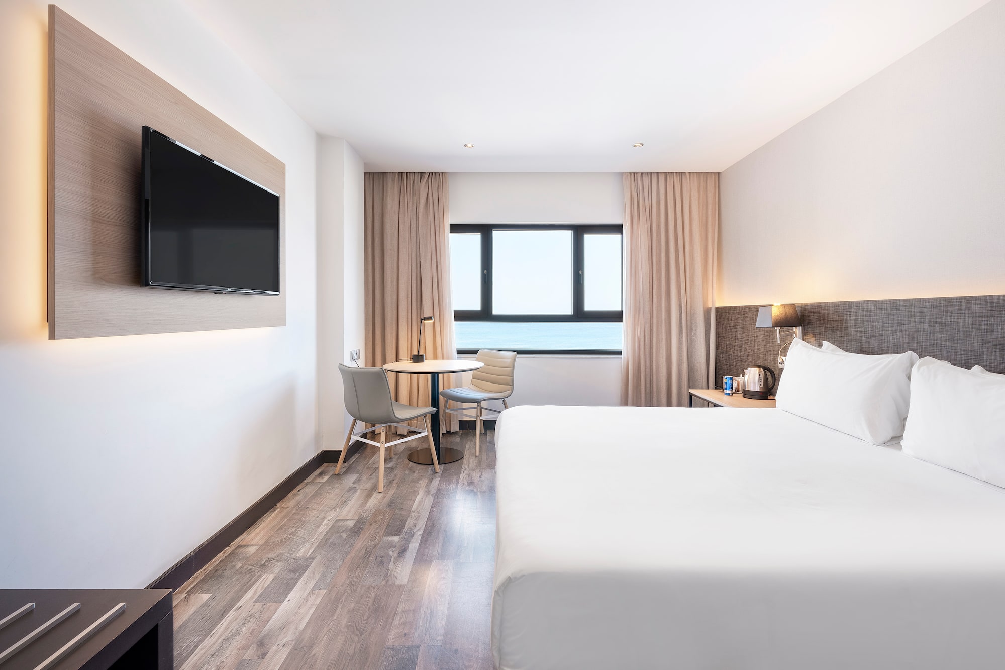 a room with a bed and a television