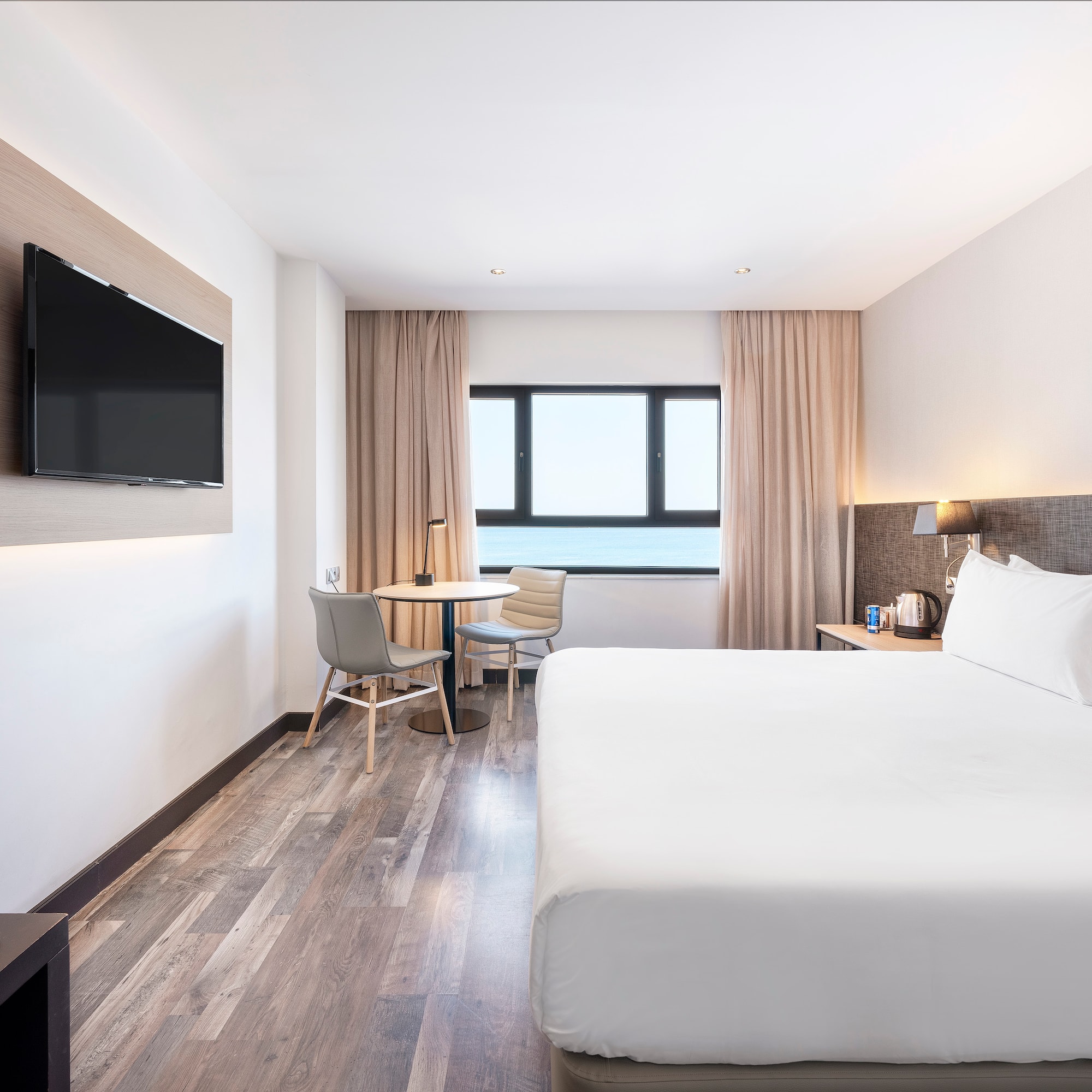 a room with a bed and a television