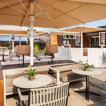 a patio with tables and chairs