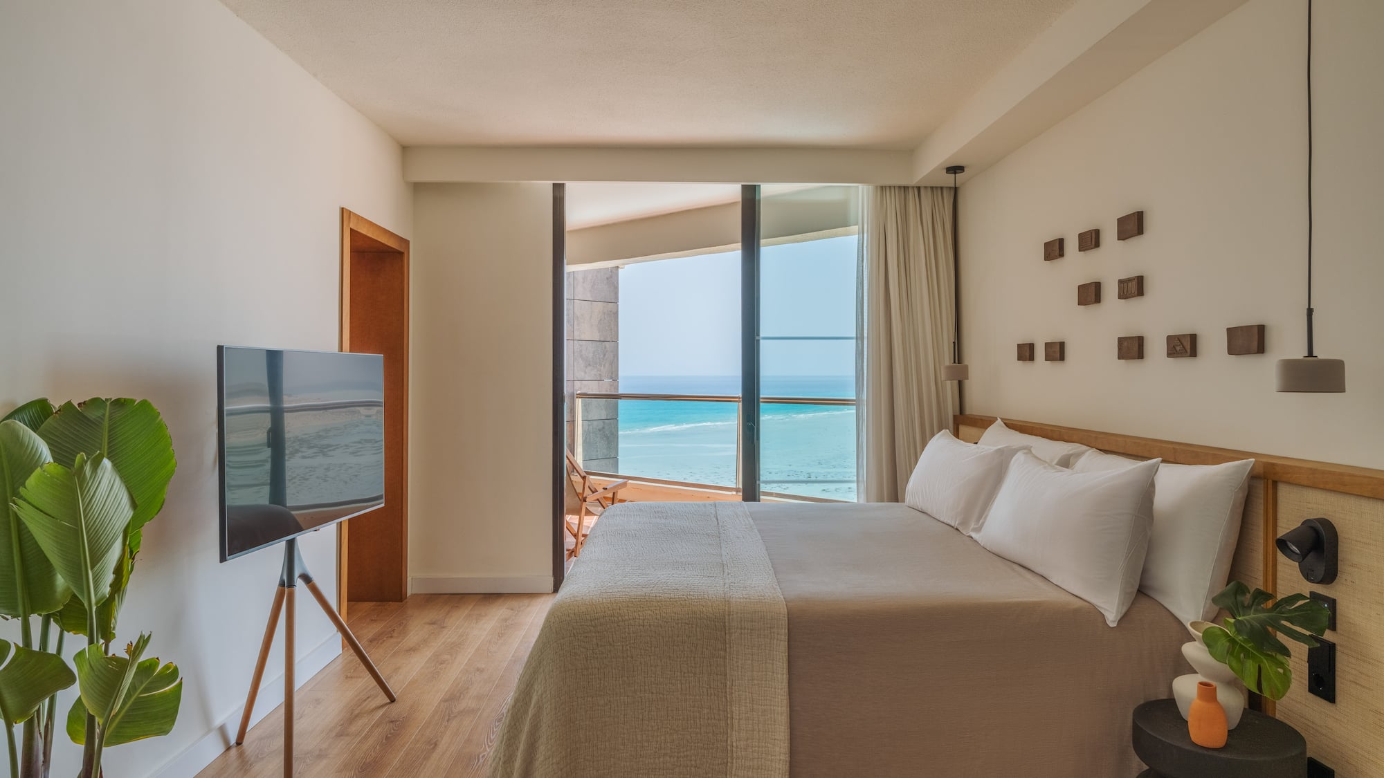 a bedroom with a television and a large window