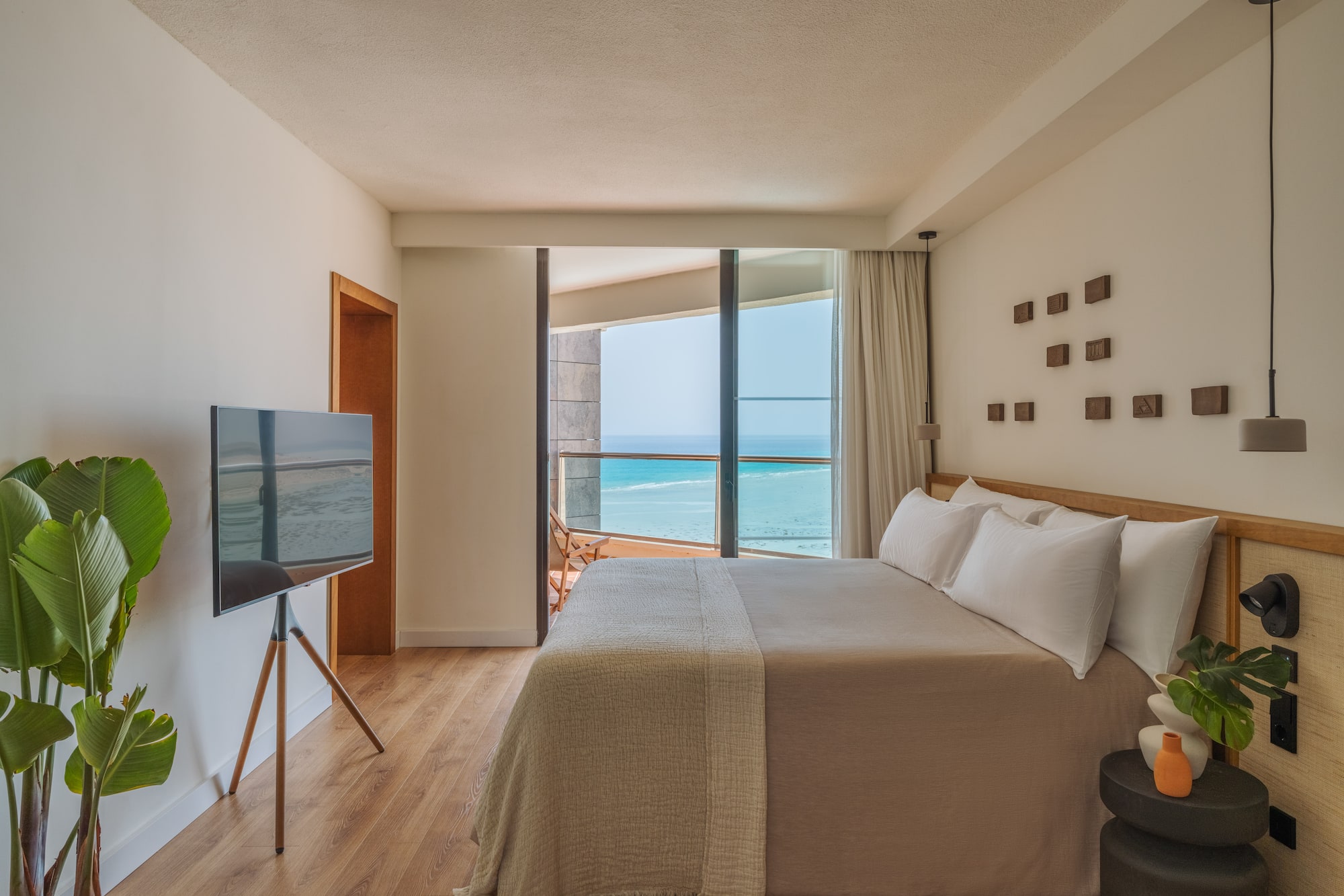 a bedroom with a television and a large window